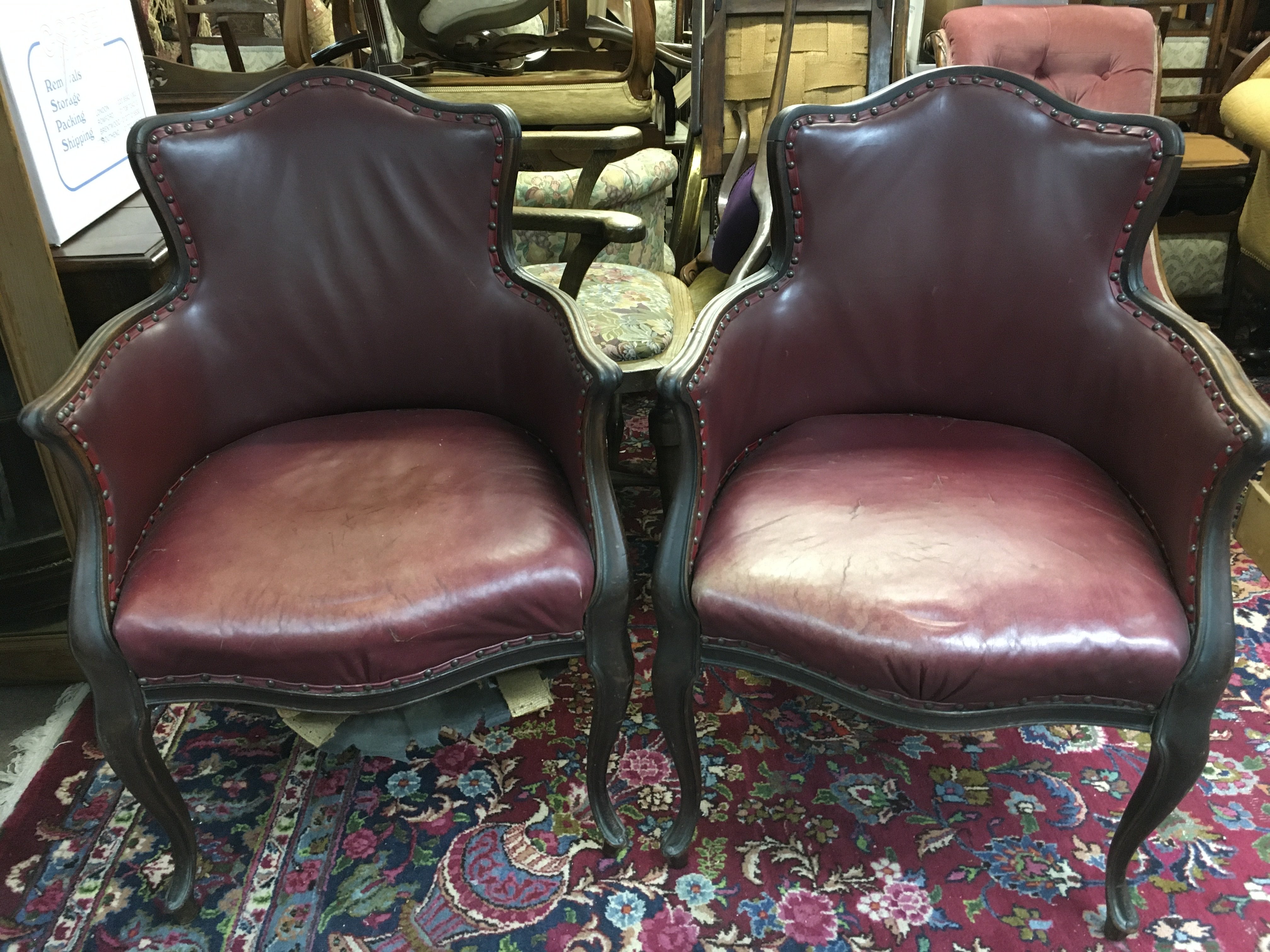 A pair of red leather upholstered tub chairs , 94cm tall 62cm wide