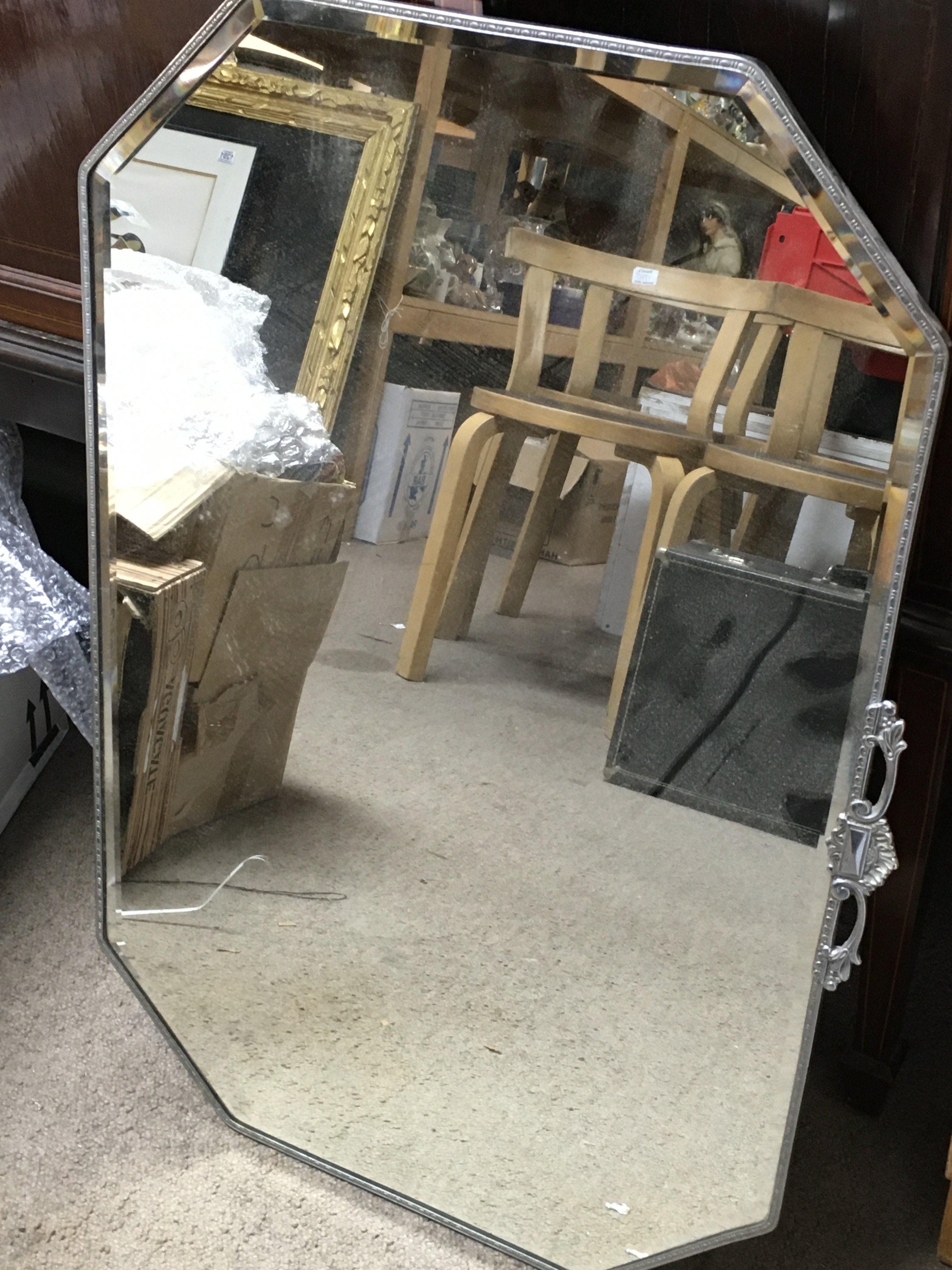 A bevelled edge mirror 49cm wide 75cm tall. No reserve
