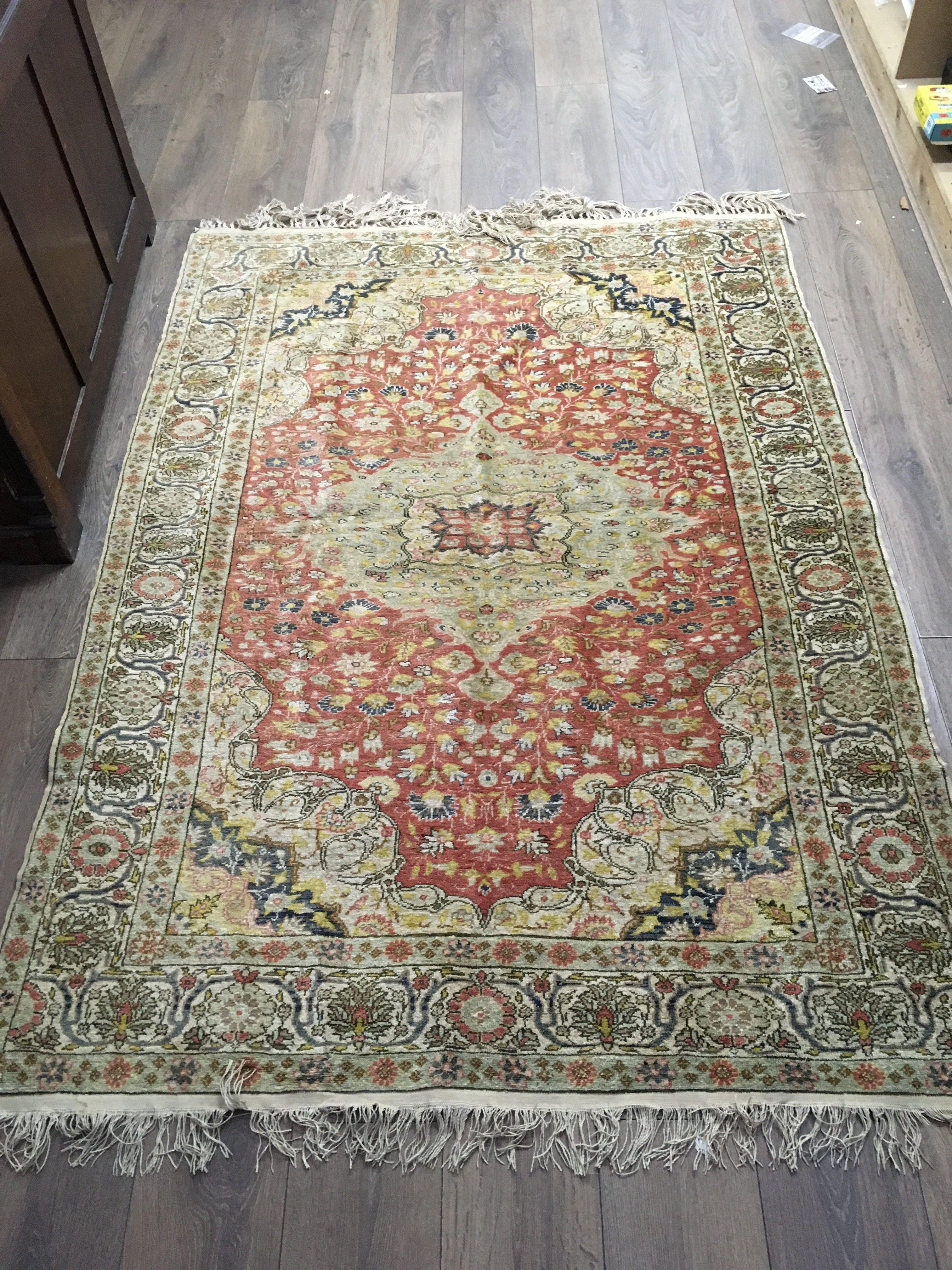 A part silk Persian rug, dimensions 138cm wide 194cm long