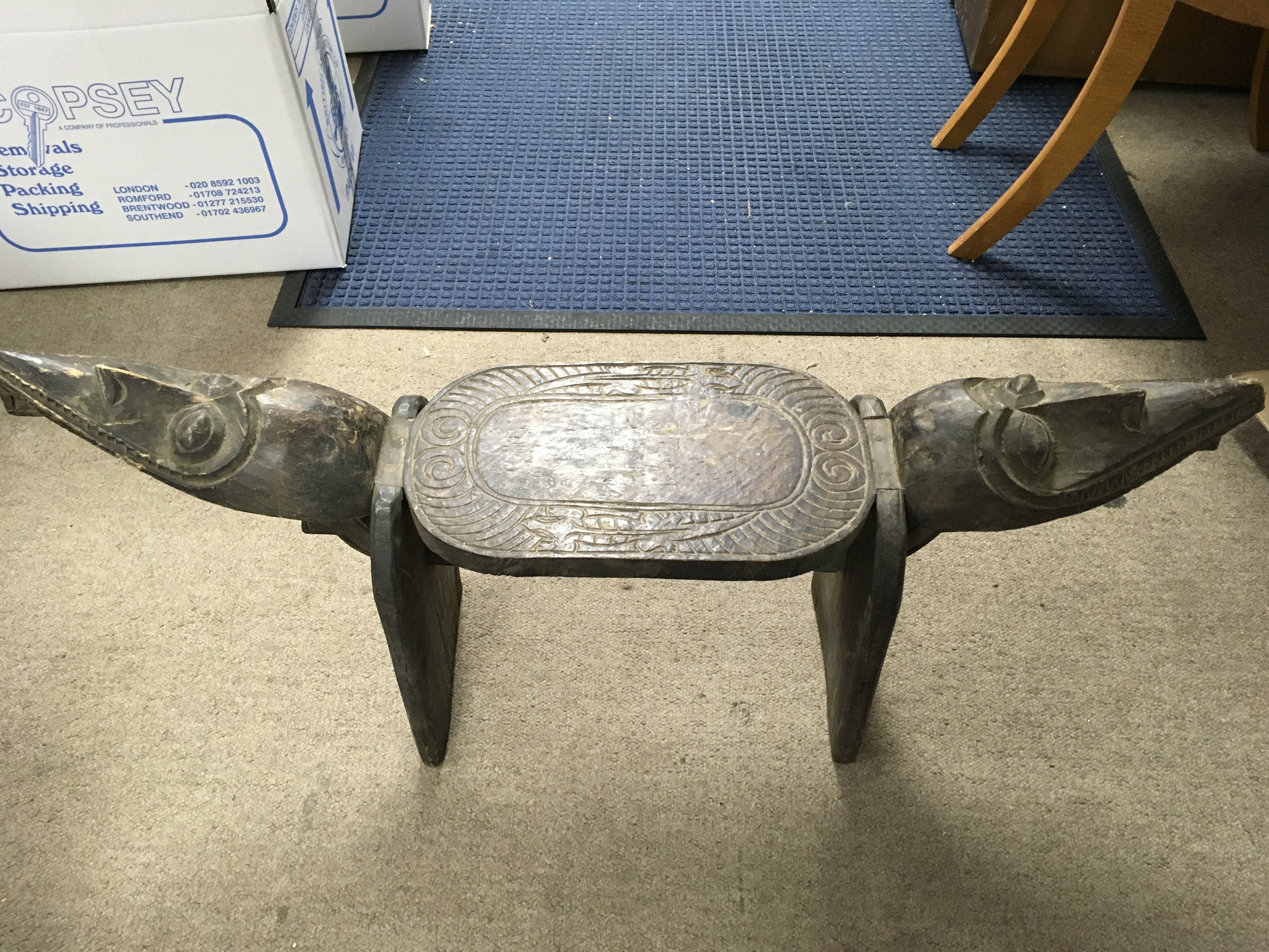 A hand carved African stool. Length 90cm, height 43cm.