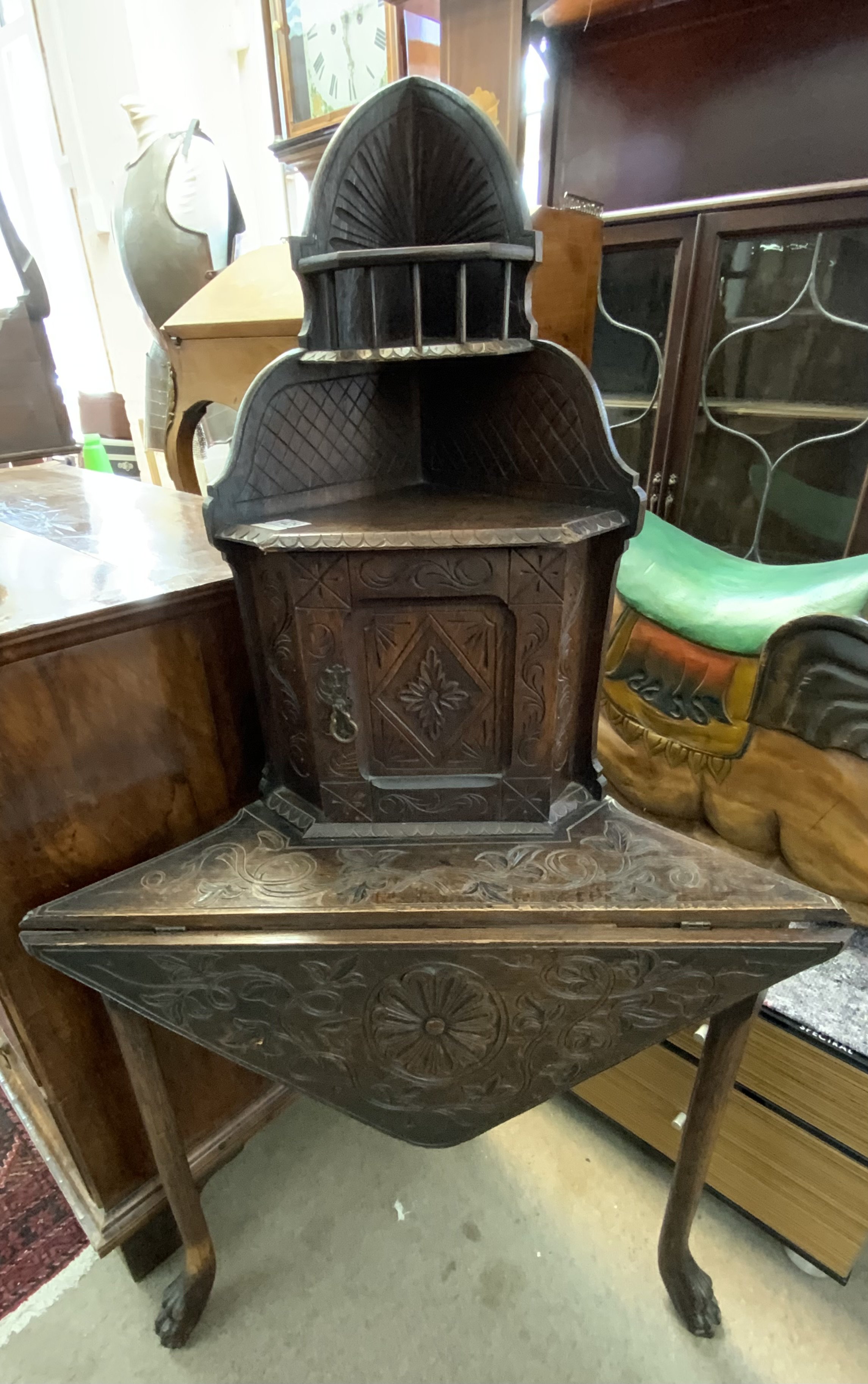 A small carved oak corner desk with drop flap front. 137cm x 55cm