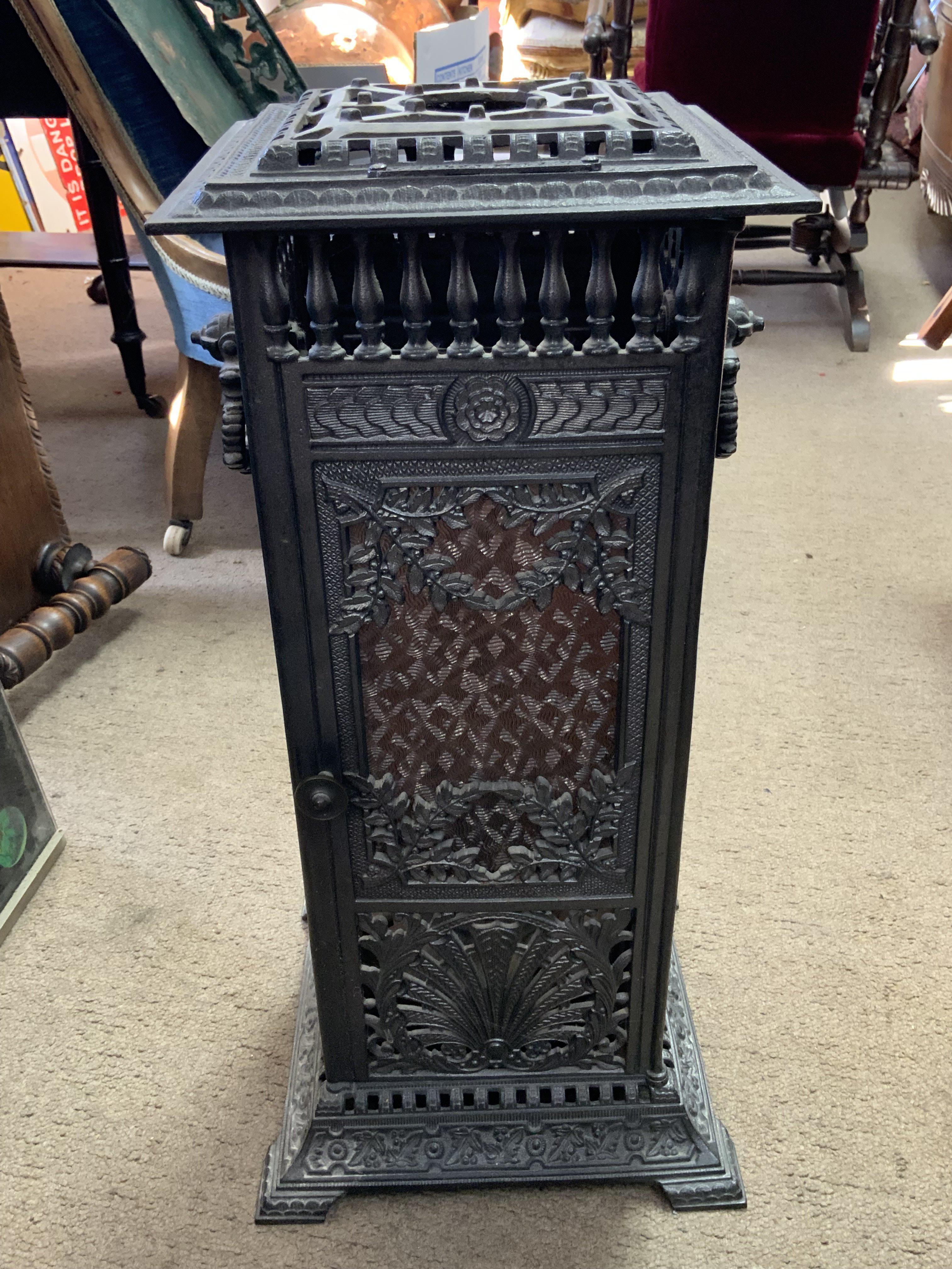 A cast iron Veritas stove. 59cm x 26cm x 26cm