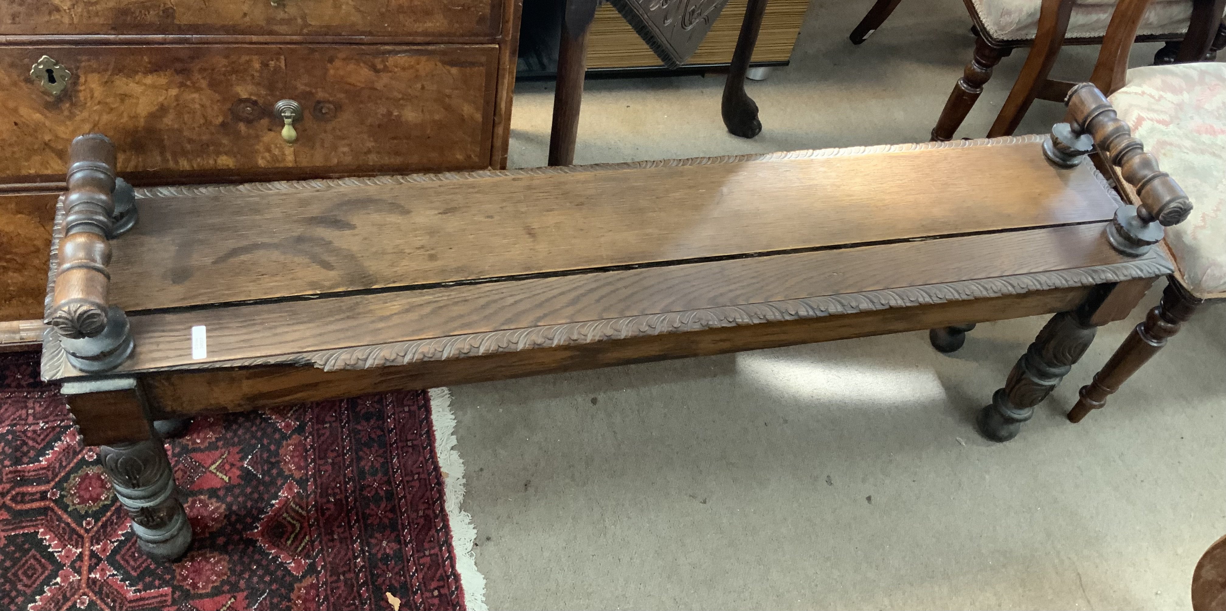 An antique oak duet stool. 136cm x 28cm x 34cm