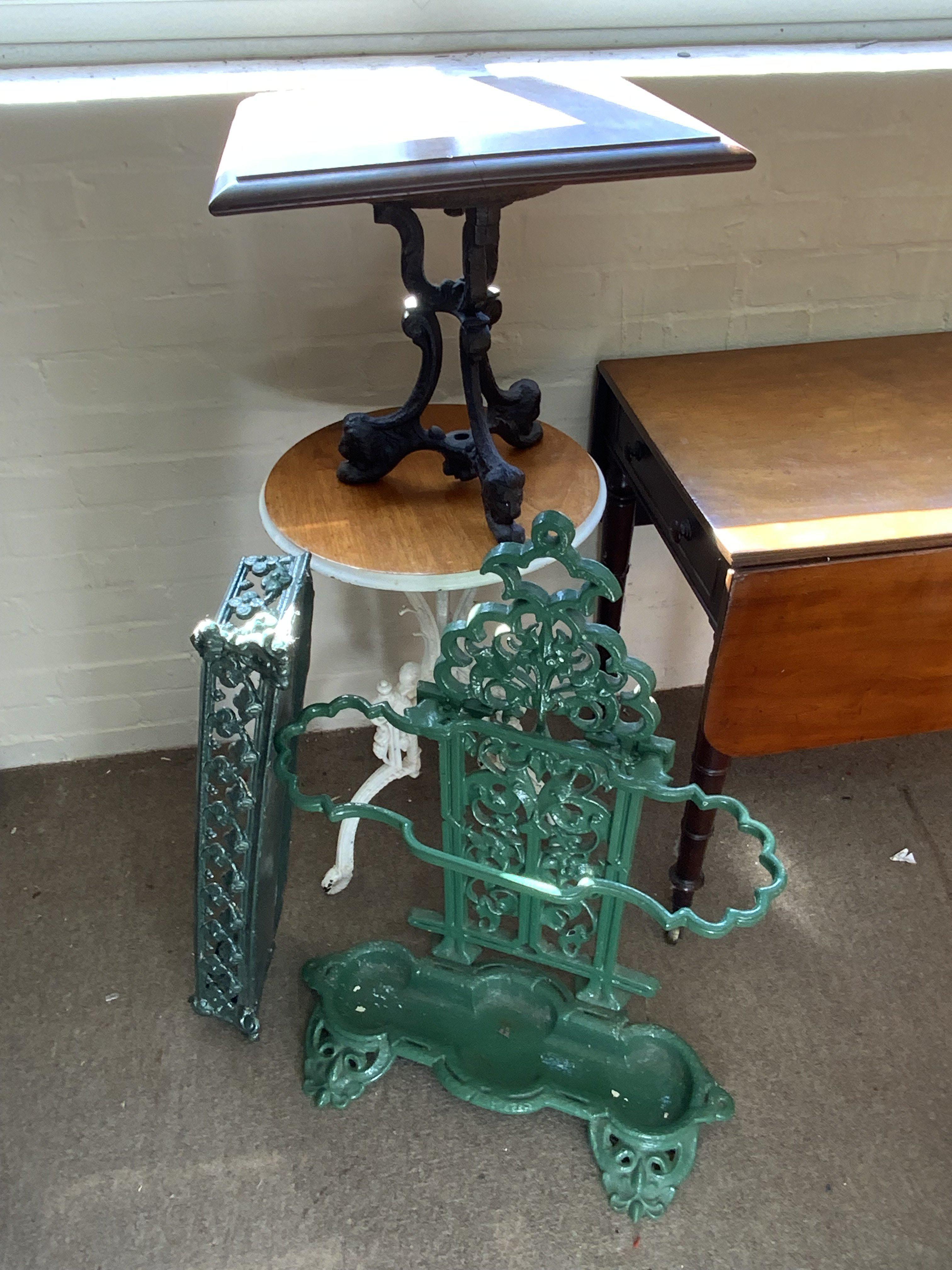 2 cast iron based side tables, cast iron umbrella stick stand, etc.