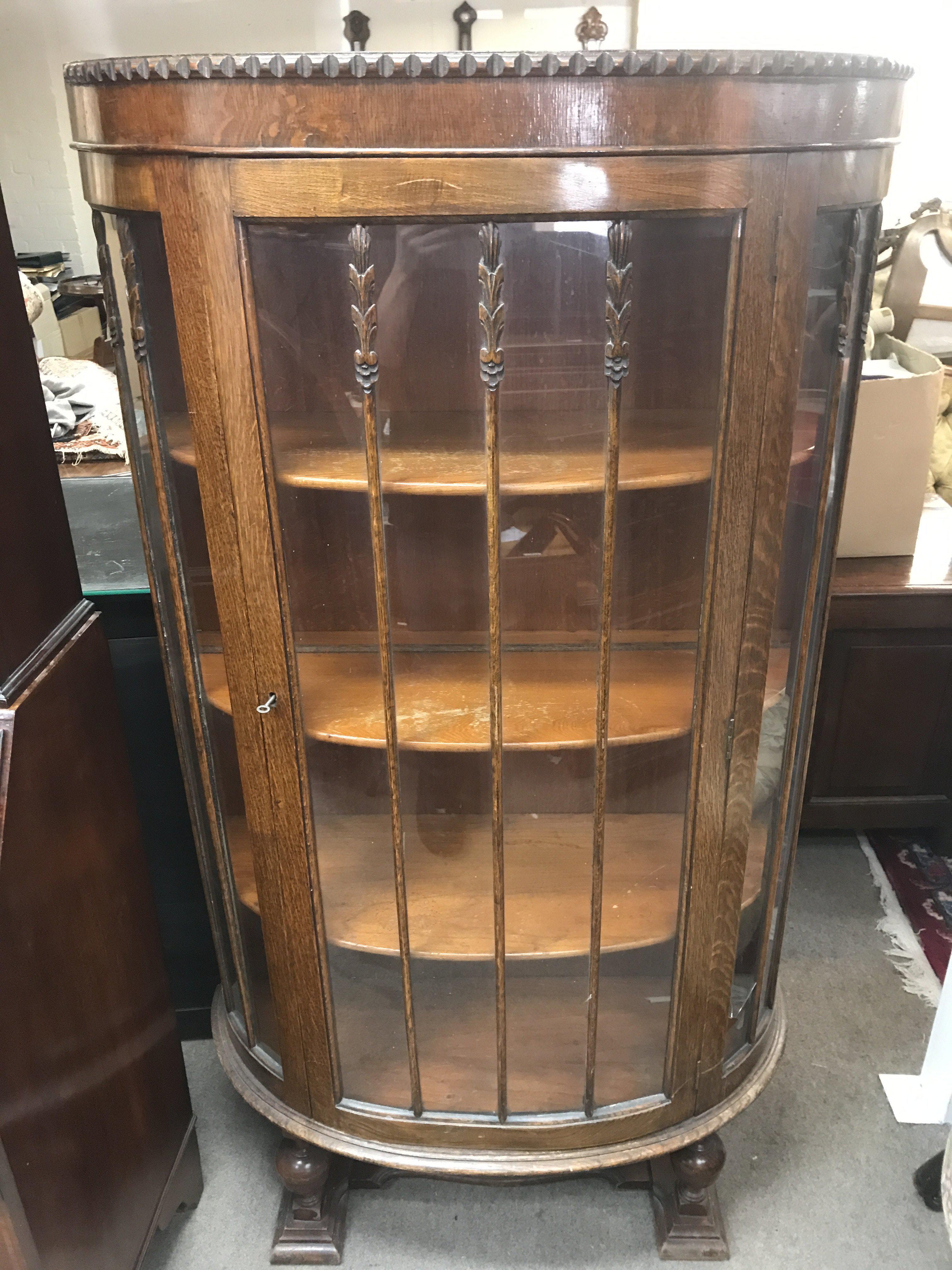 A semi circular oak glass door cabinet, 160cm tall 88cm wide