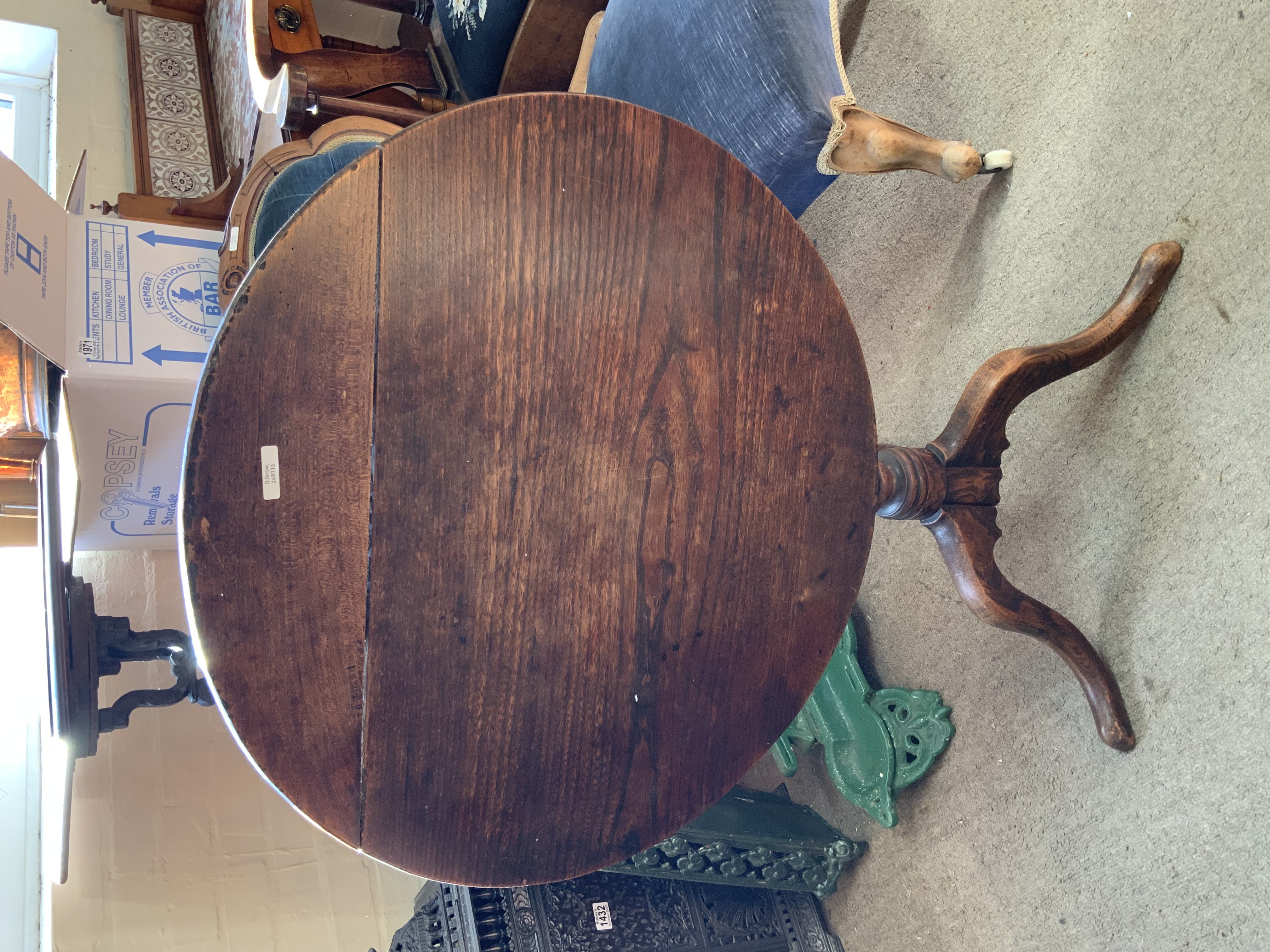 A small oak tripod base tilt topped table.