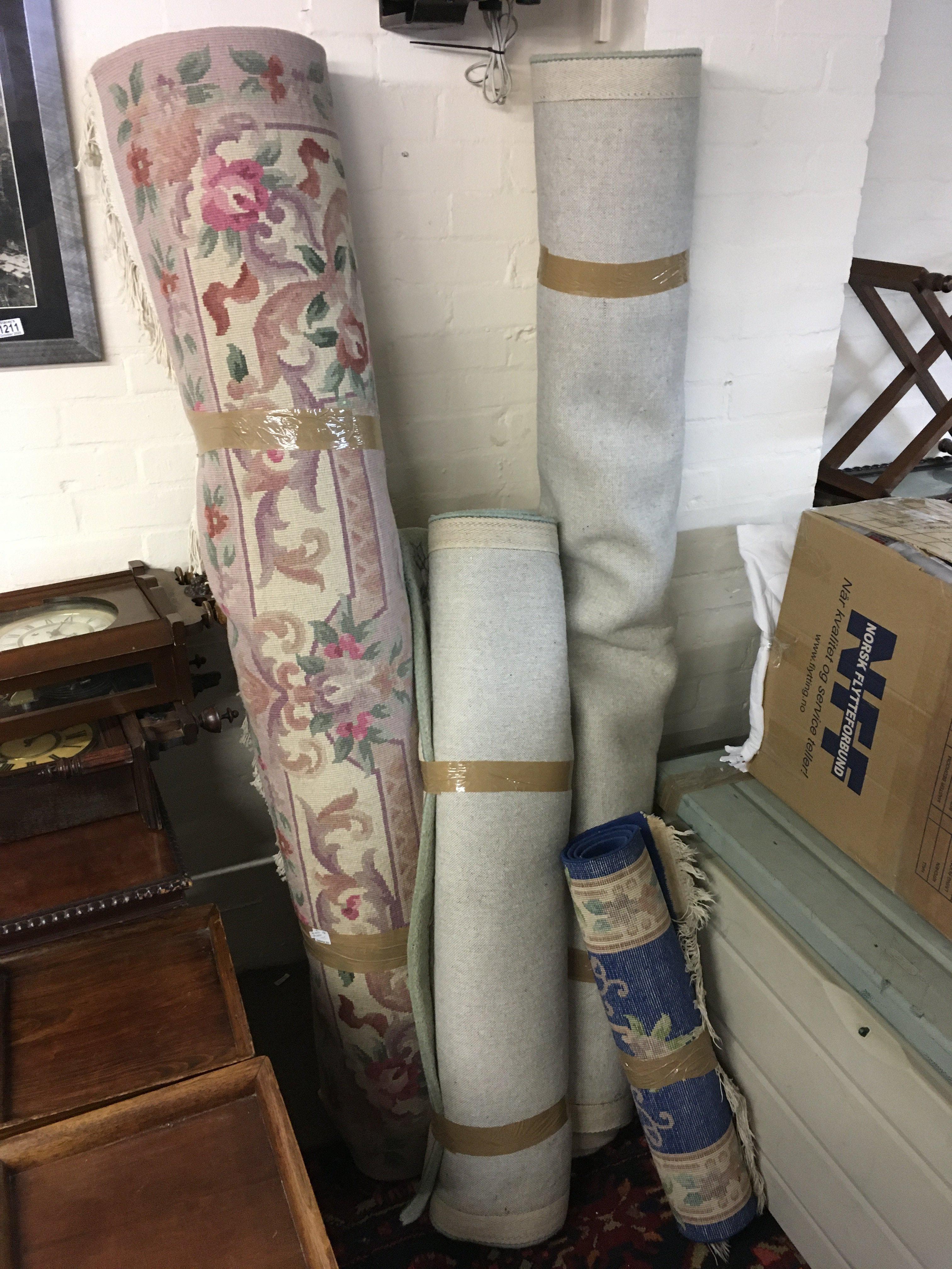 Four Chinese floral patterned rugs including large examples in green and light pink colours and one small blue rug