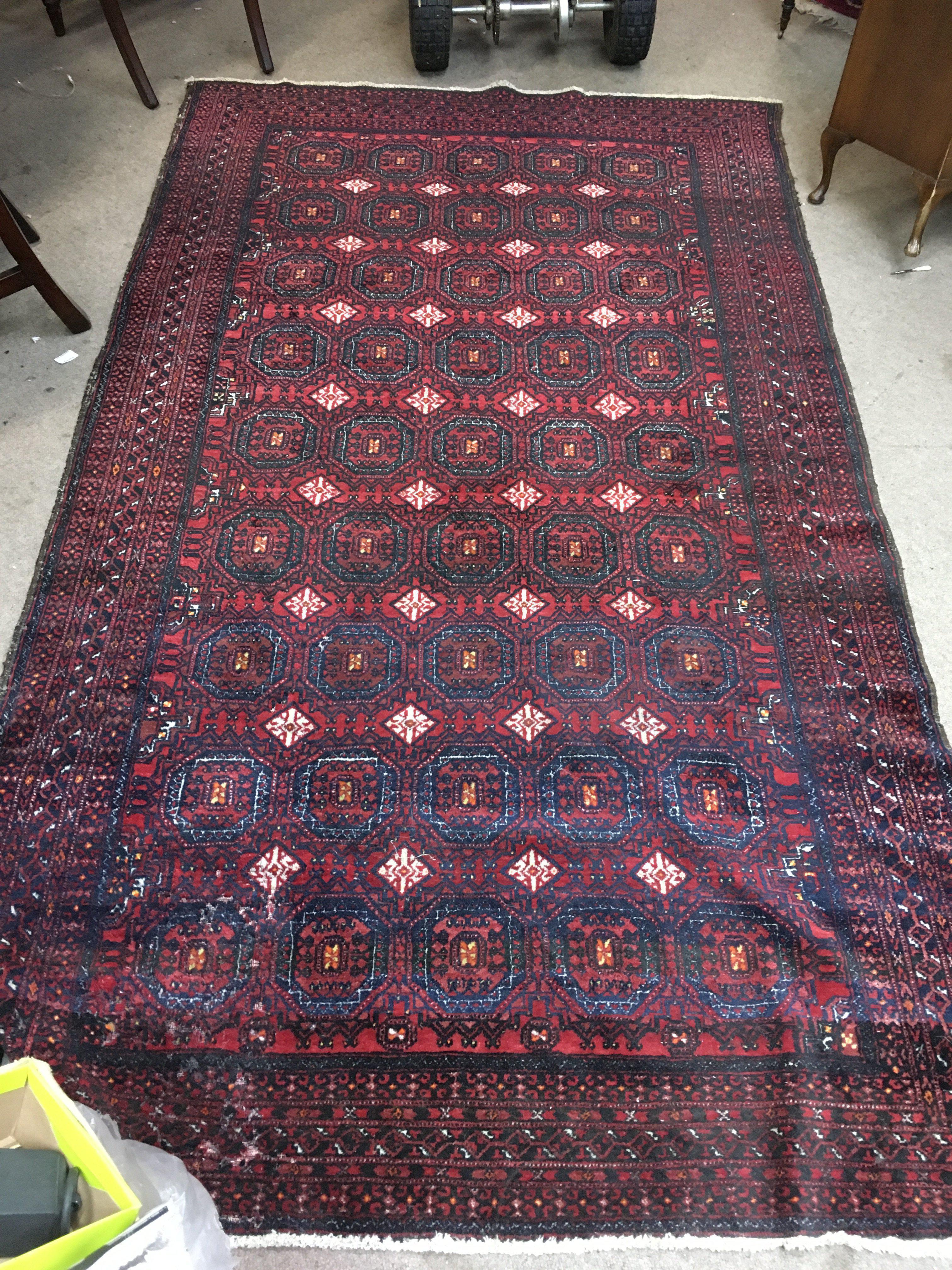 A Persian wool rug. Approx size 143x247cm.