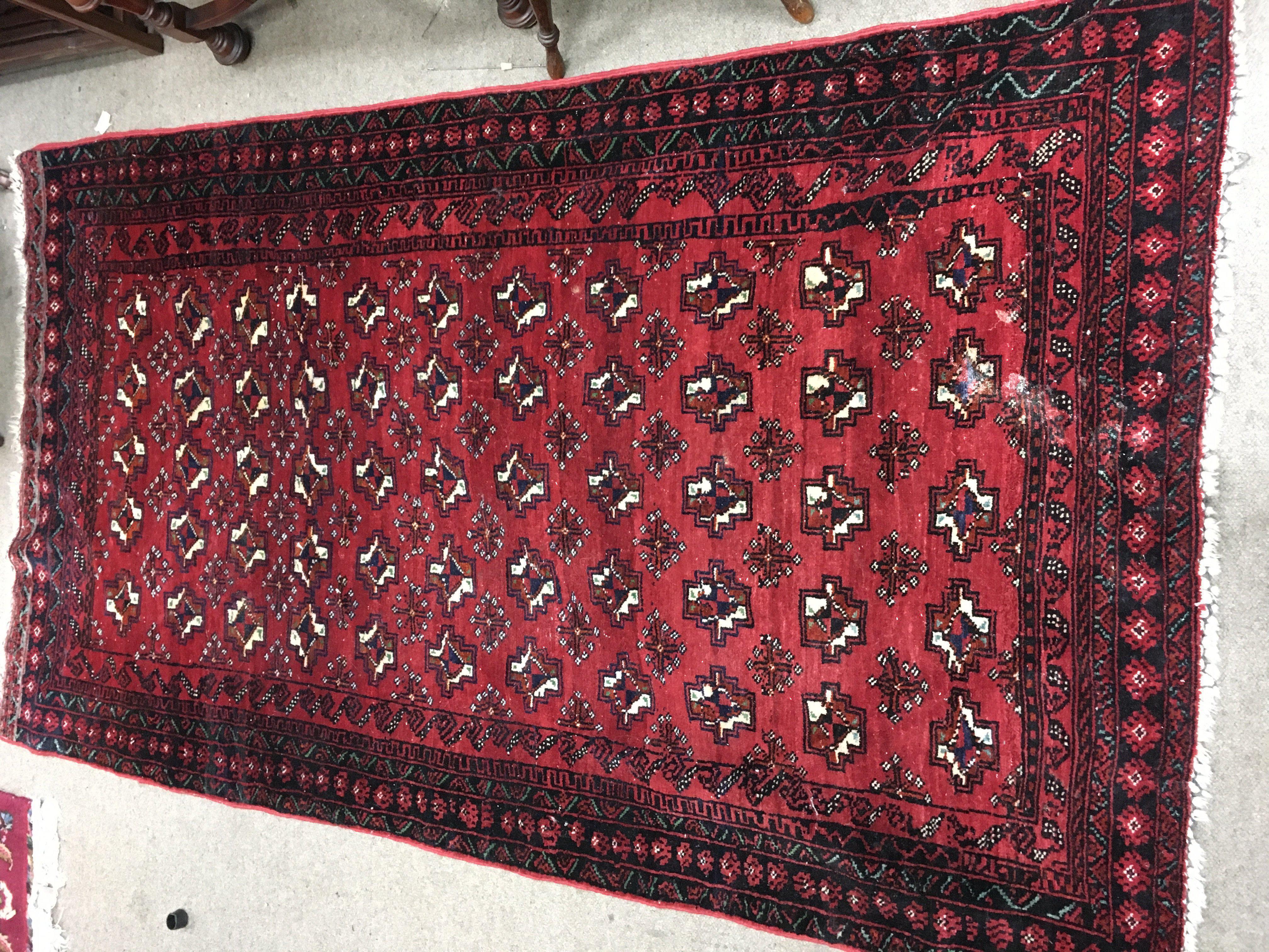 A Persian wool rug. Approx measurements 110x184cm