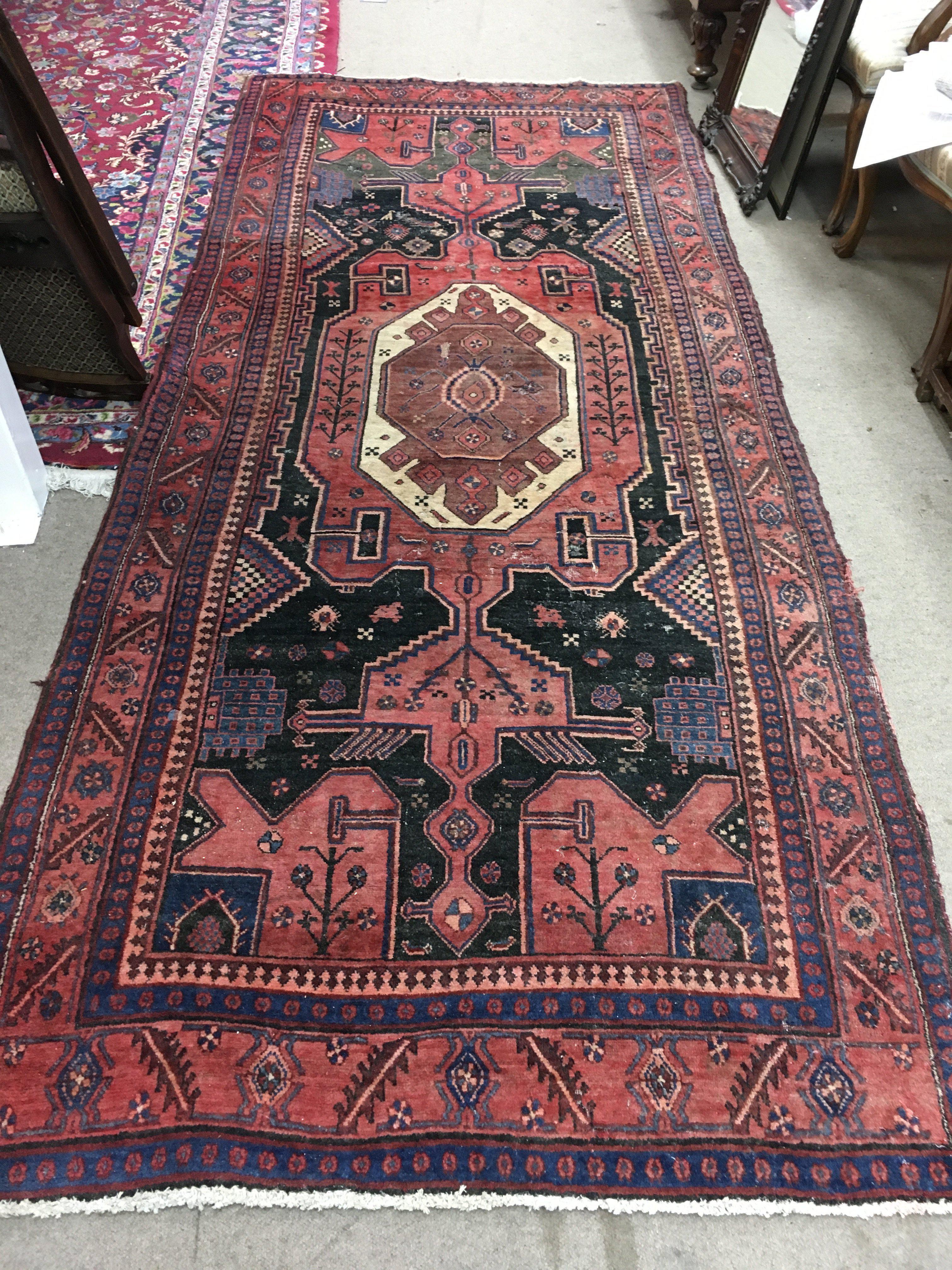 A Persian wool rug. Approx measurements 313x126cm.