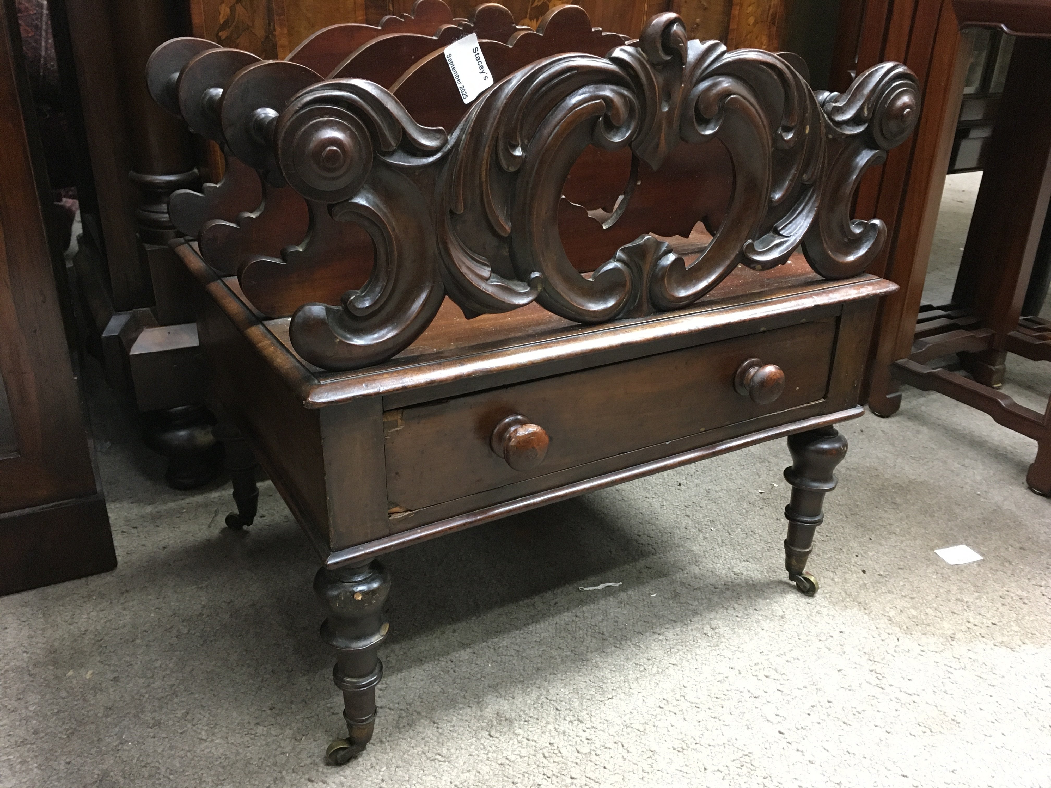 A Victorian mahogany Canterbury with three open sections, fitted with a single drawer on turned legs