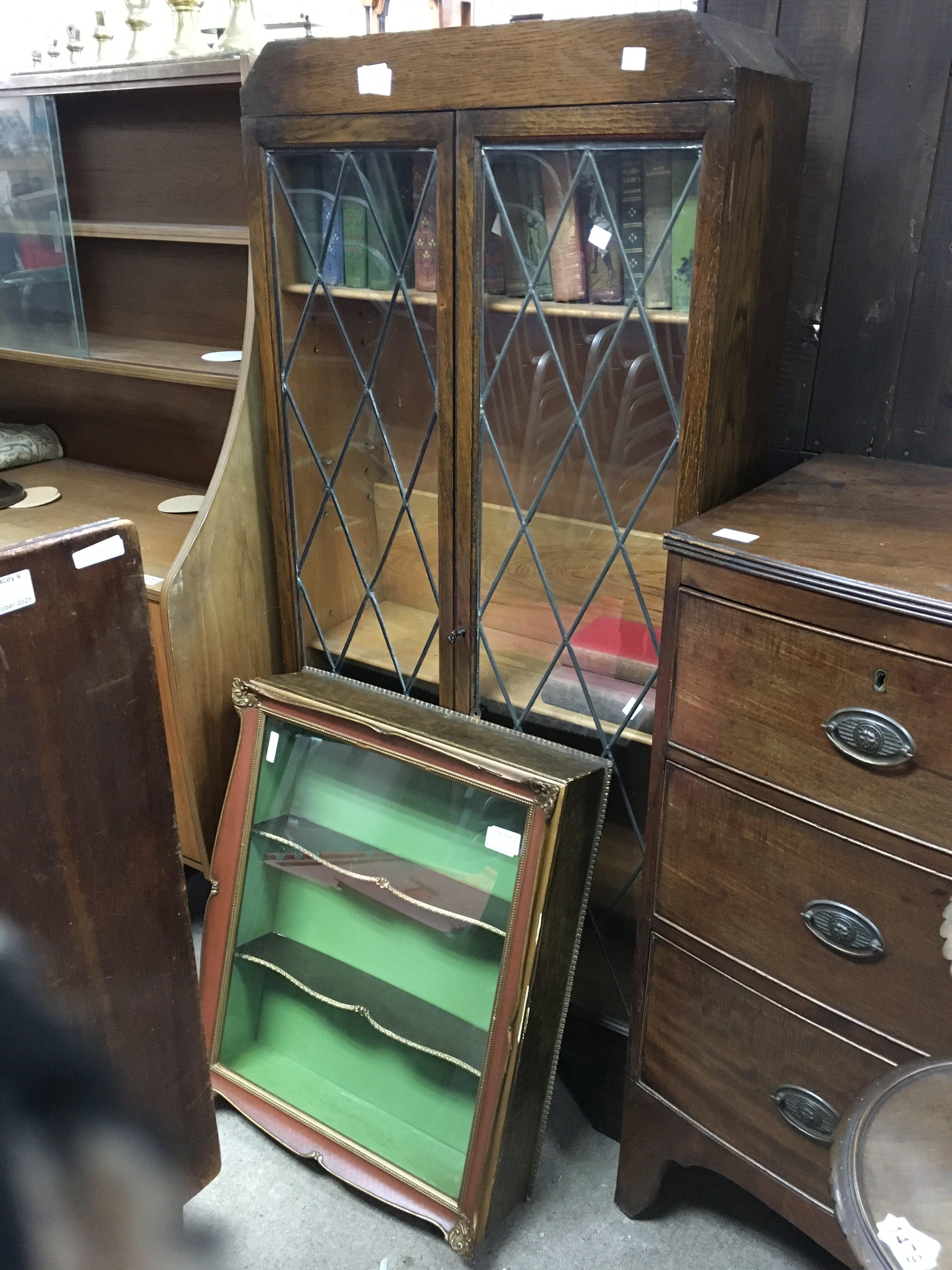 A Cole toon of furniture comprising two oak bookcases, a hanging display cabinet, a folding card table and a mahogany jardiniere stand
