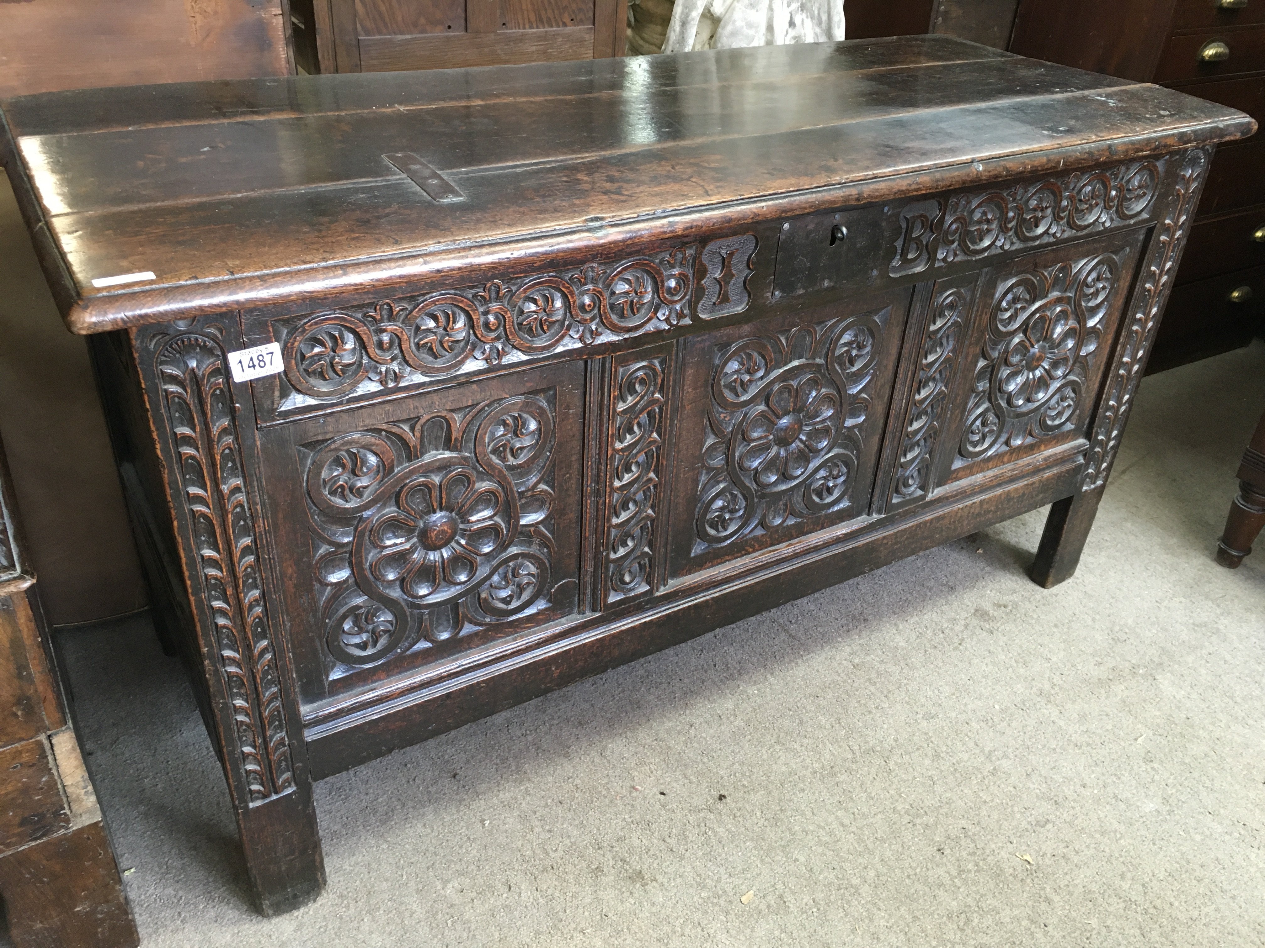A large oak blanket box, the hinged lid above a carved panel front. 58cm x 140cm x 75 cm