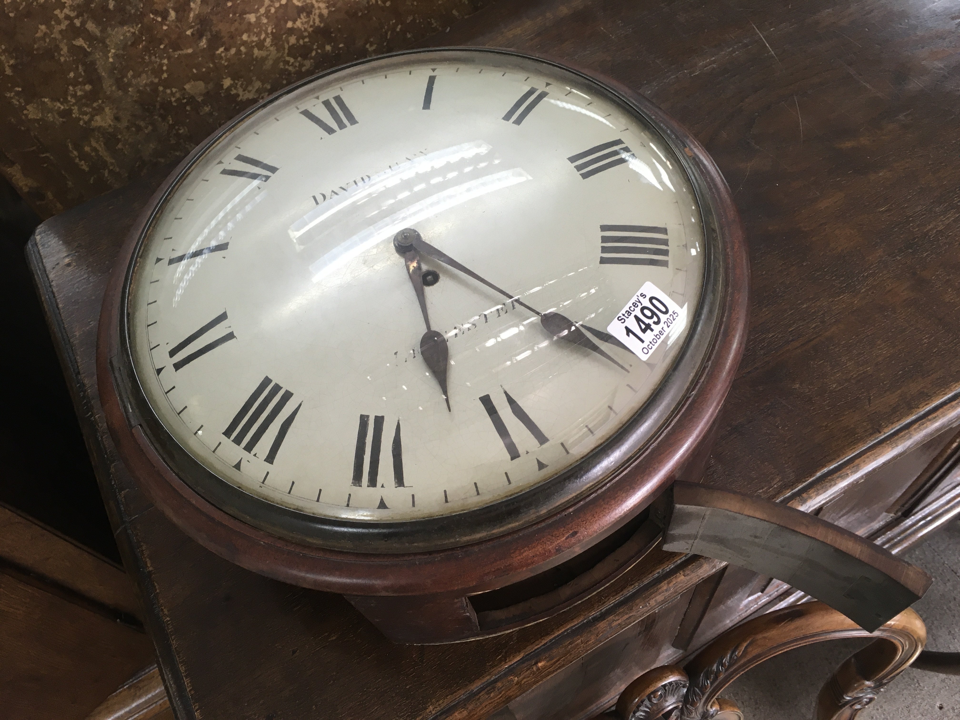 A mahogany drop dial wall clock, with fuse movement. The painted dial with Roman numerals. 32cm across