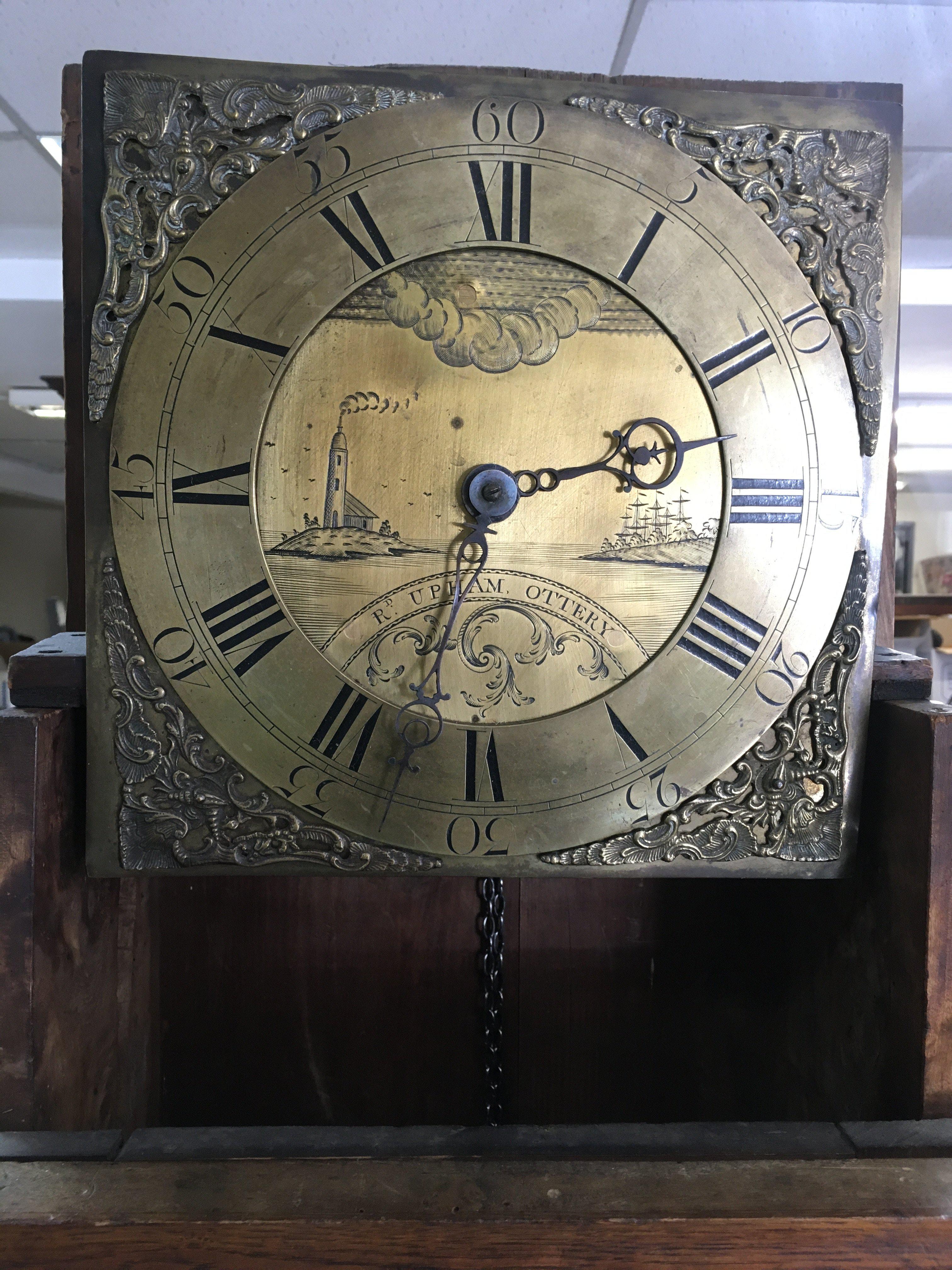 An oak 30 hour long case clock having brass dial with Roman numerals