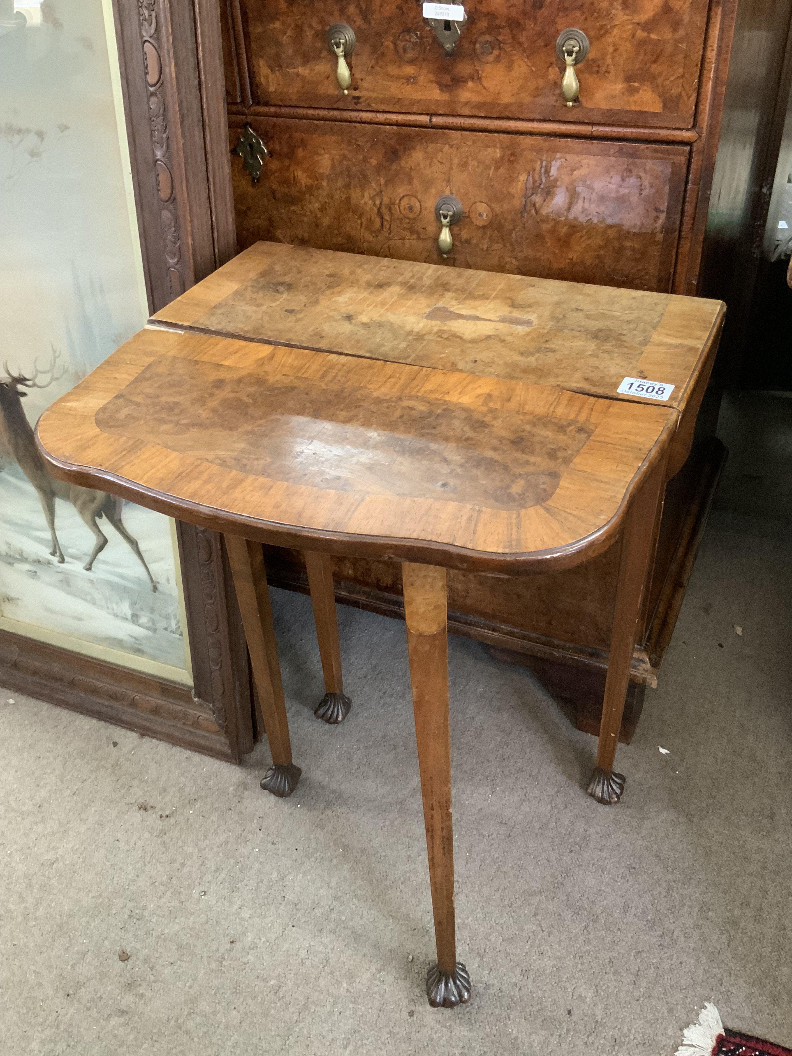 A small walnut veneered occasional table. 48cm x 22cm x 70cm. (In need of restoration).