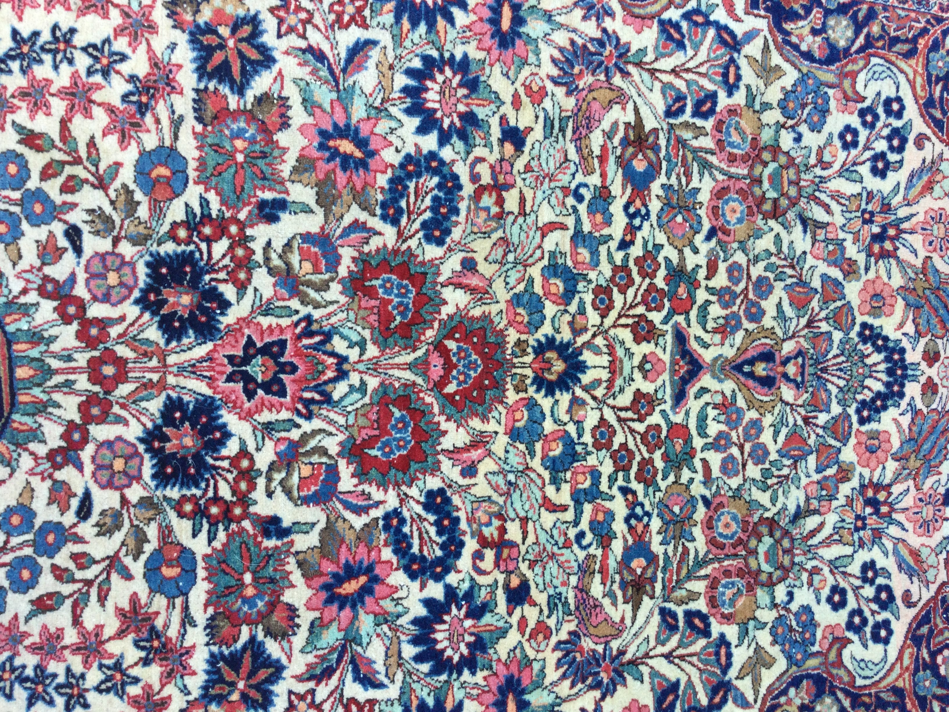 A Persian rug with floral centre and board 210 x 130 cm .