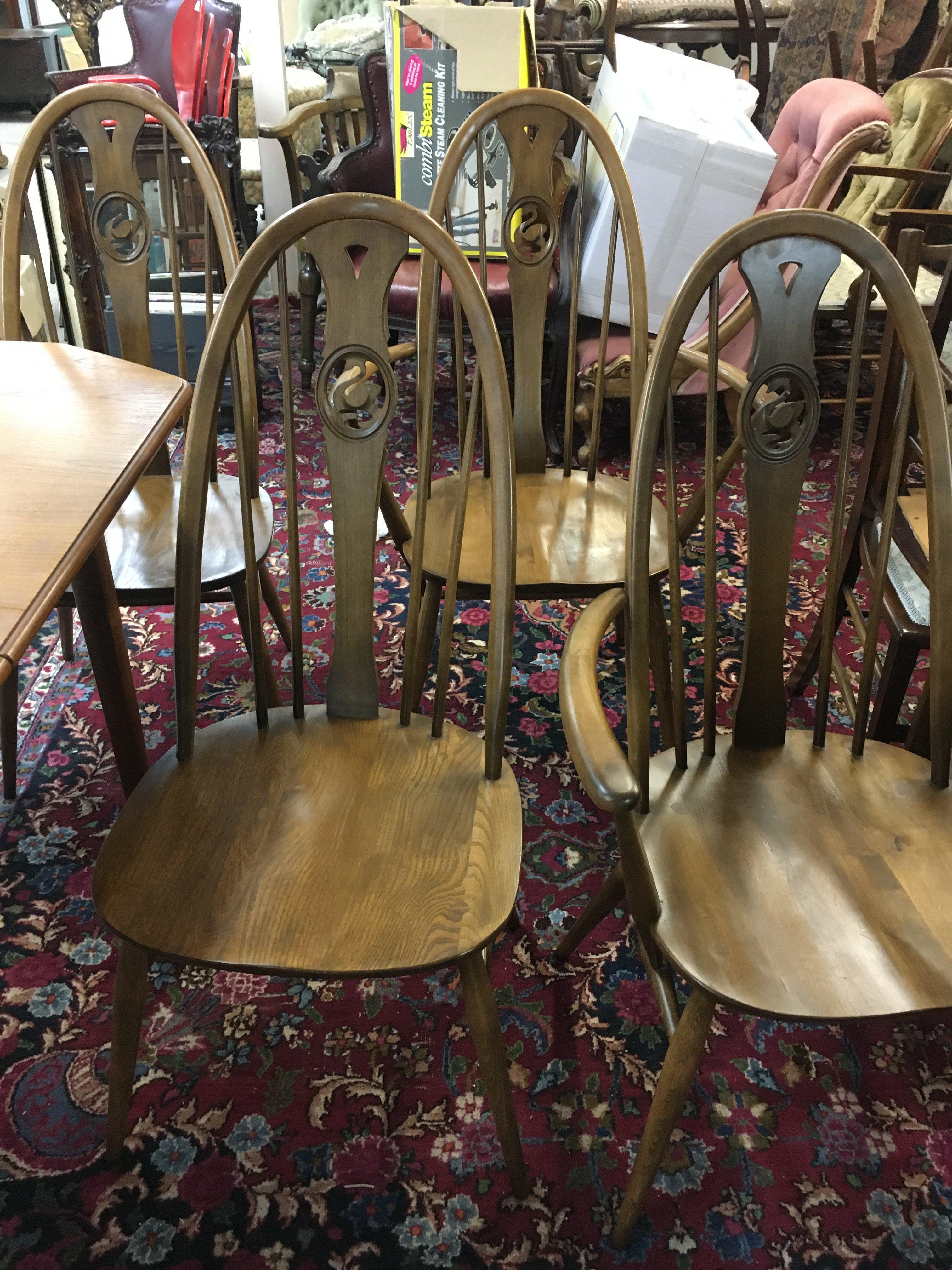 A mid century teak extending dining table and four swan back ercole chairs. Dining table dimensions 148x92cm.