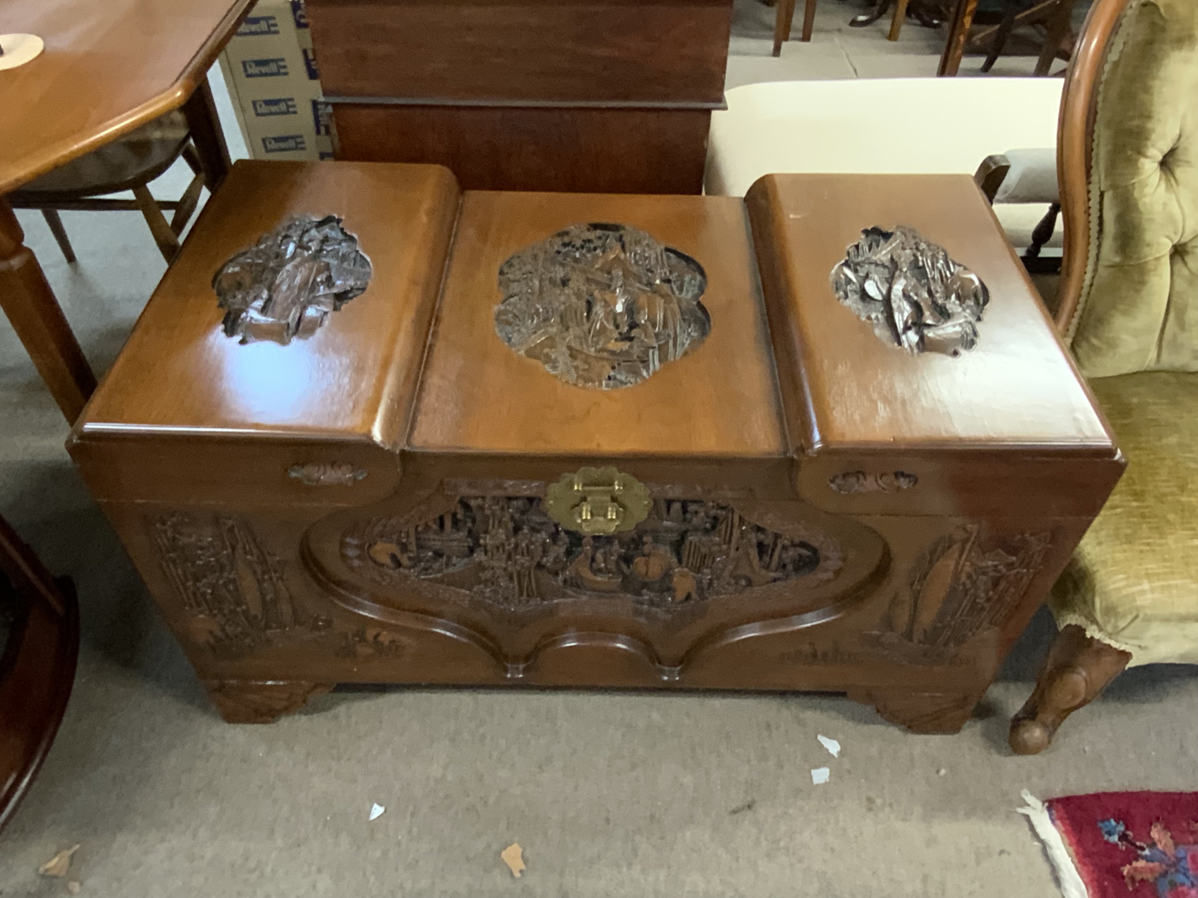 A Chinese carved wood blanket box with camphor wood lining.