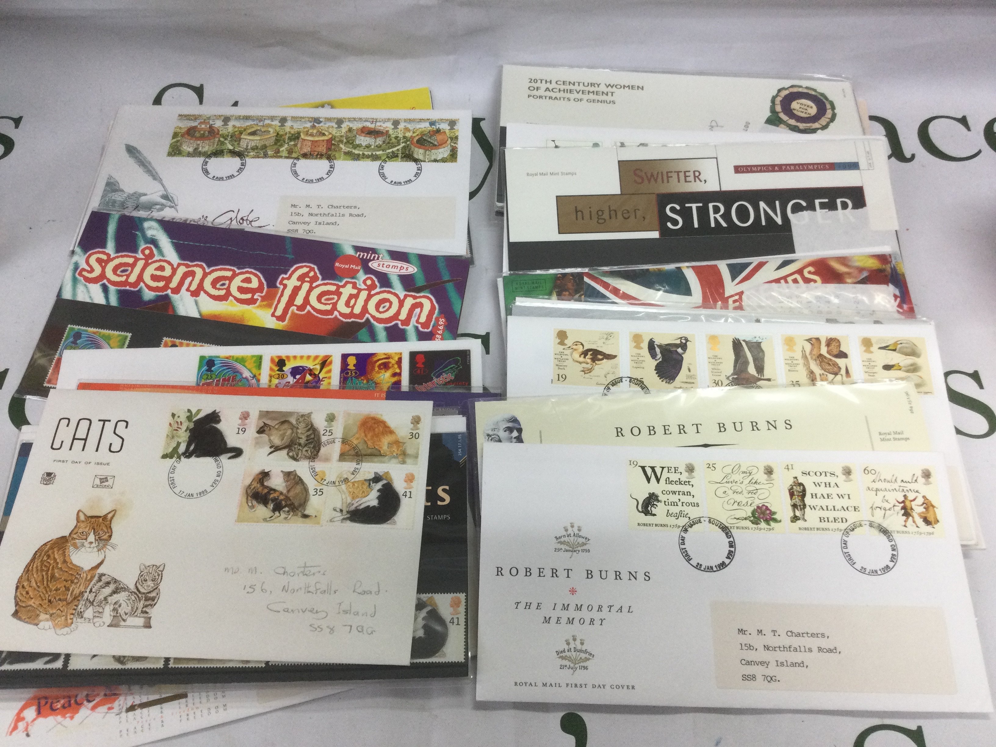 Three tins of stamps and presentation packs. Shipping category C.