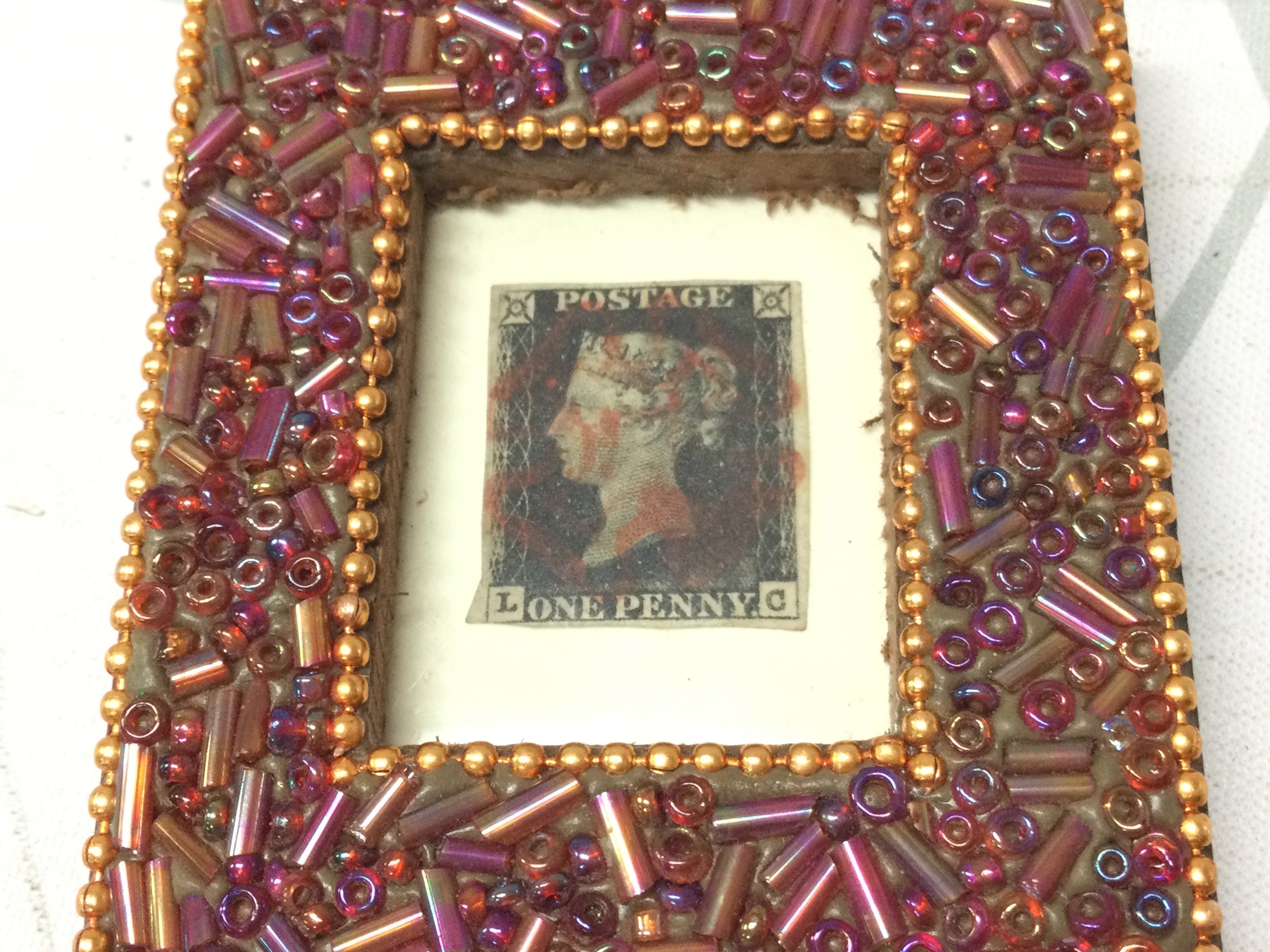 A framed penny black stamp. Postage category A