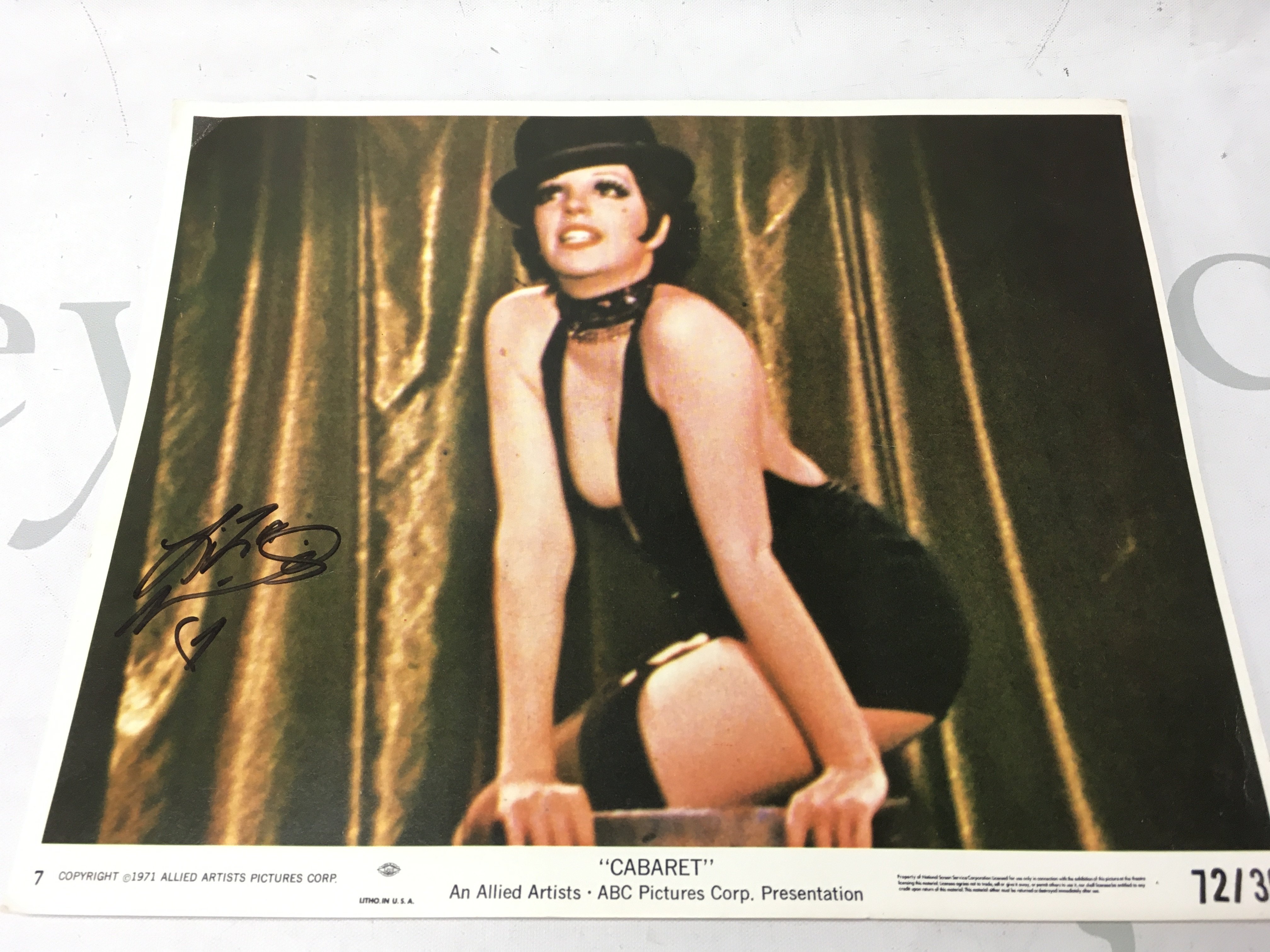 A Liza Minnelli signed Cabaret lobby card . Postage category A