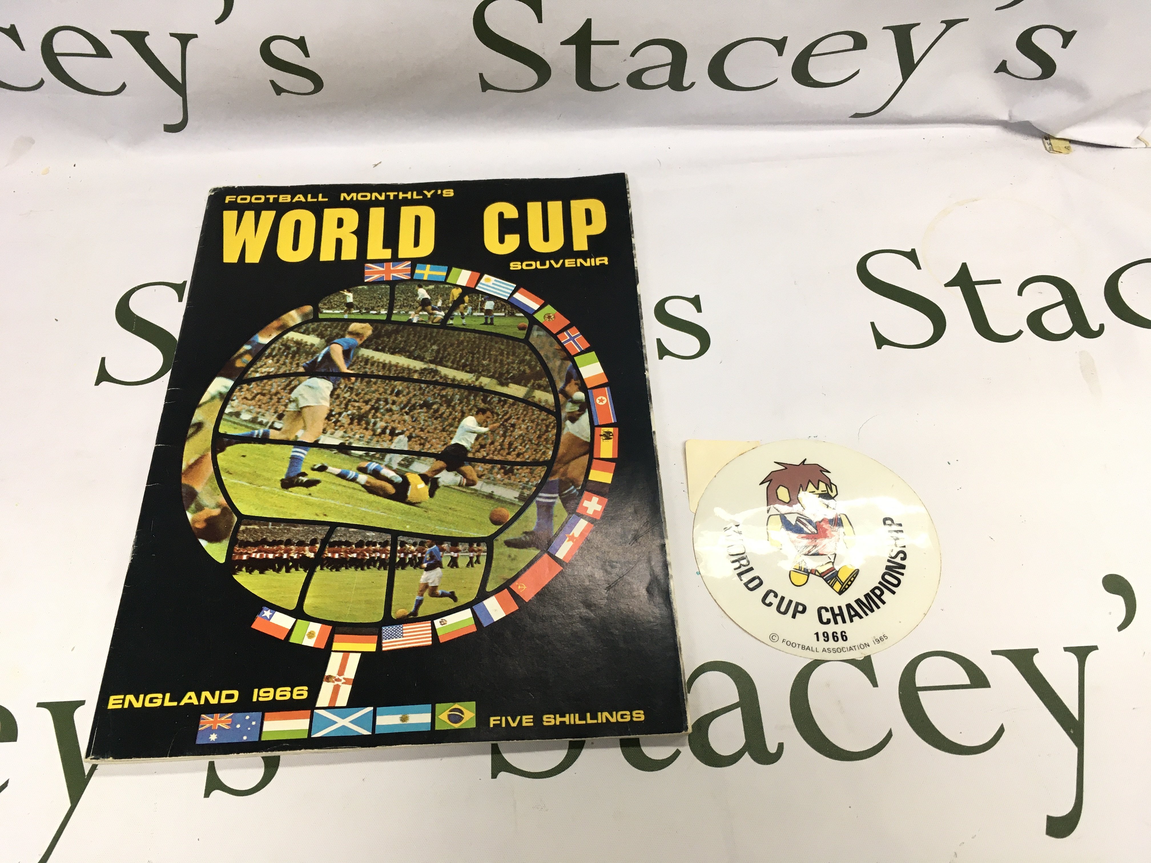 A 1966 World Cup Willy car sticker and a football monthly World Cup 1966 souvenir magazine in good condition.