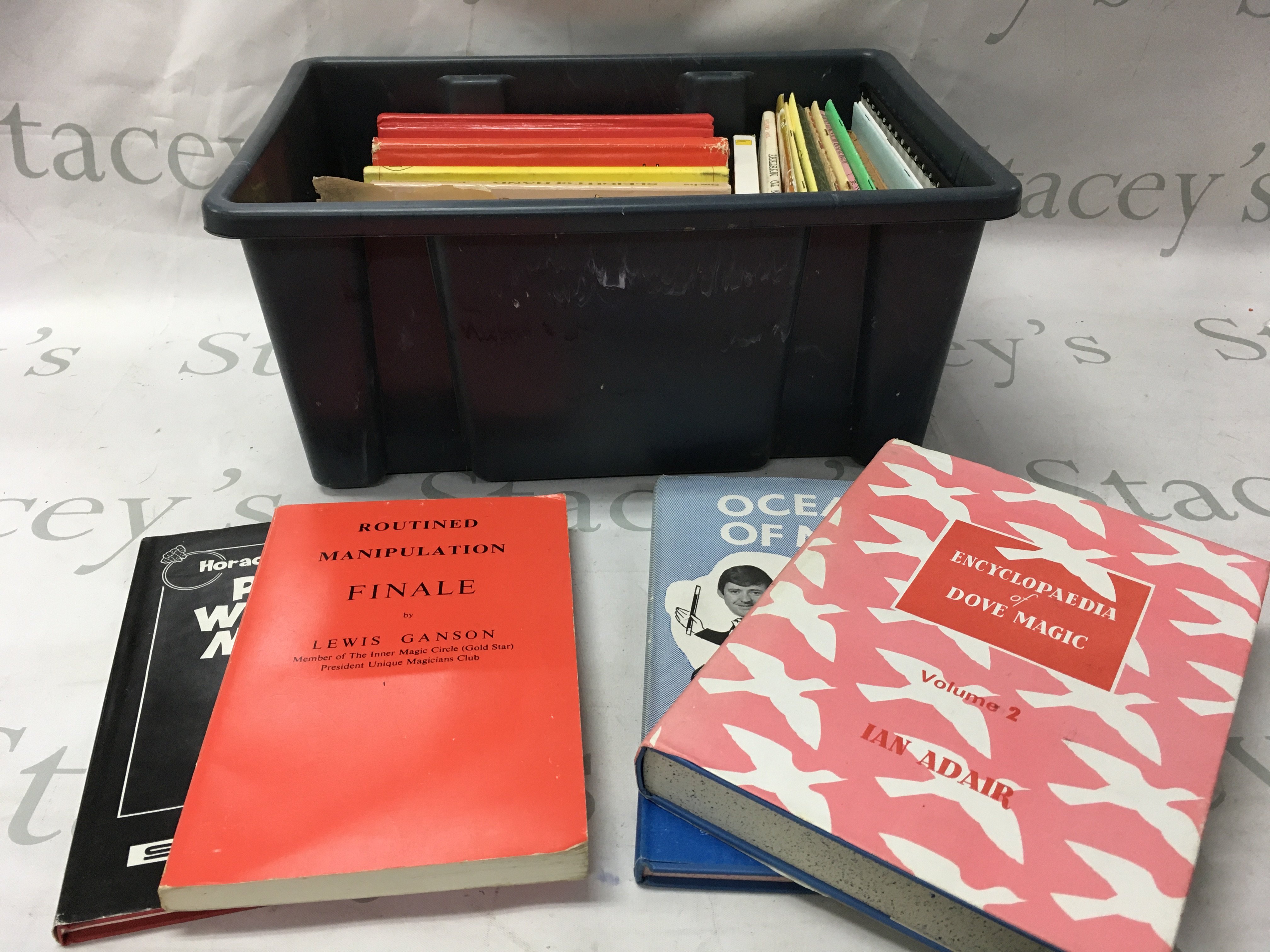 Two boxes of magic books including various magician handbooks and some encyclopaedias as well as some clown comedy books.