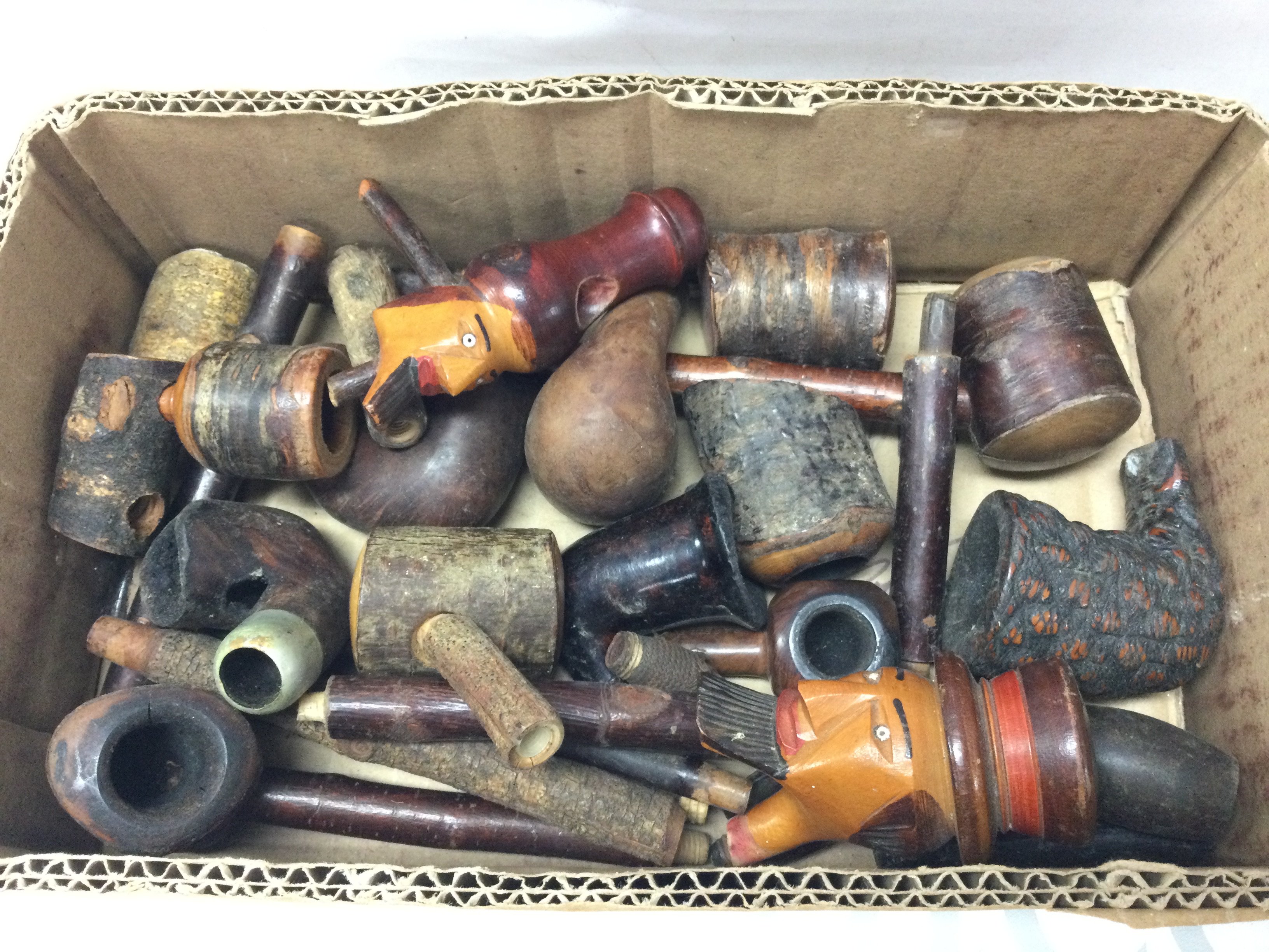 A box of old smoking pipe parts, stems and bowls . Postage category B