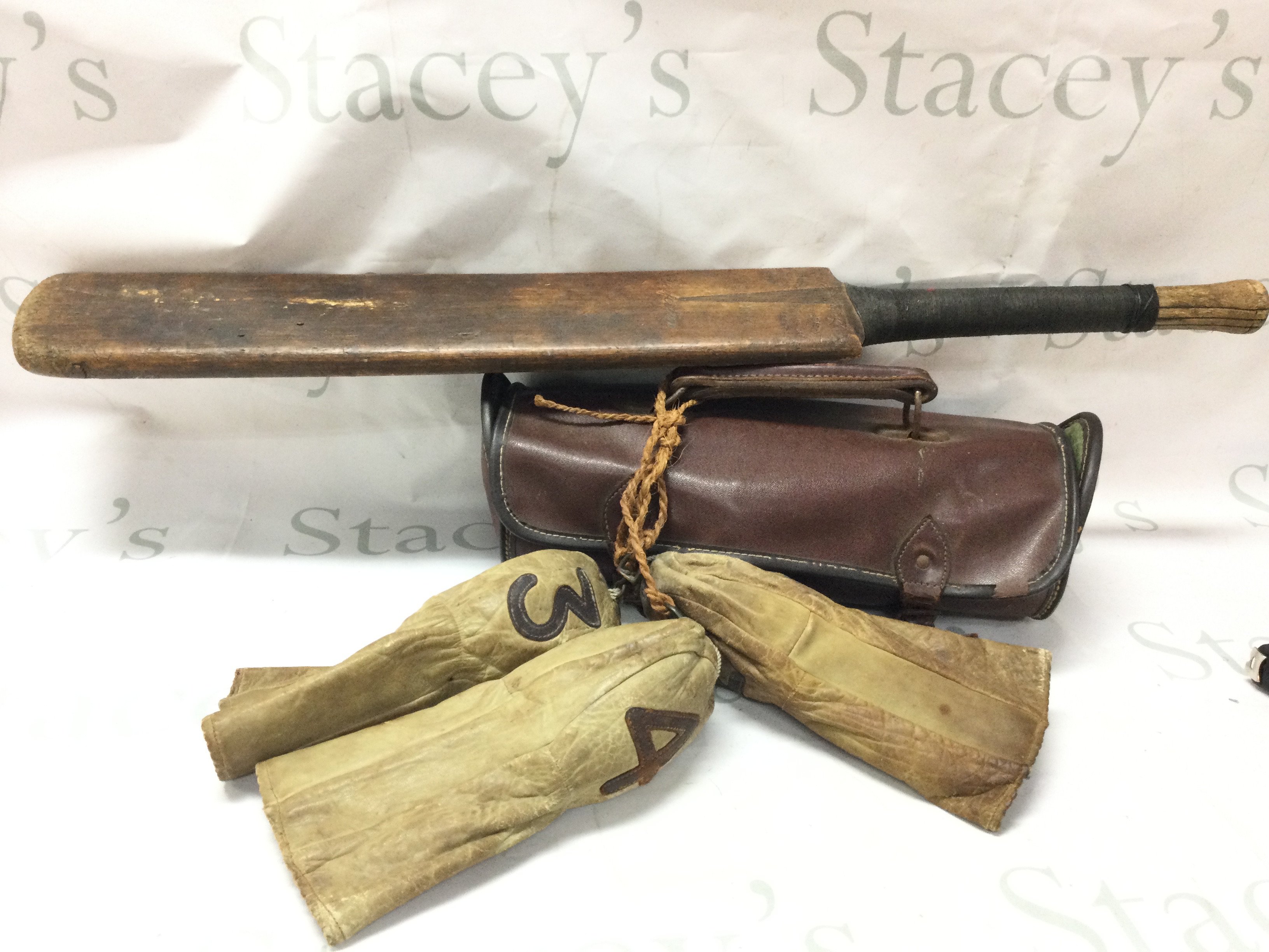 A set of three vintage bowls in leather case, cricket bat and a set of three very early leather golf club heads covers no 2,3,4 .this lot cannot be posted