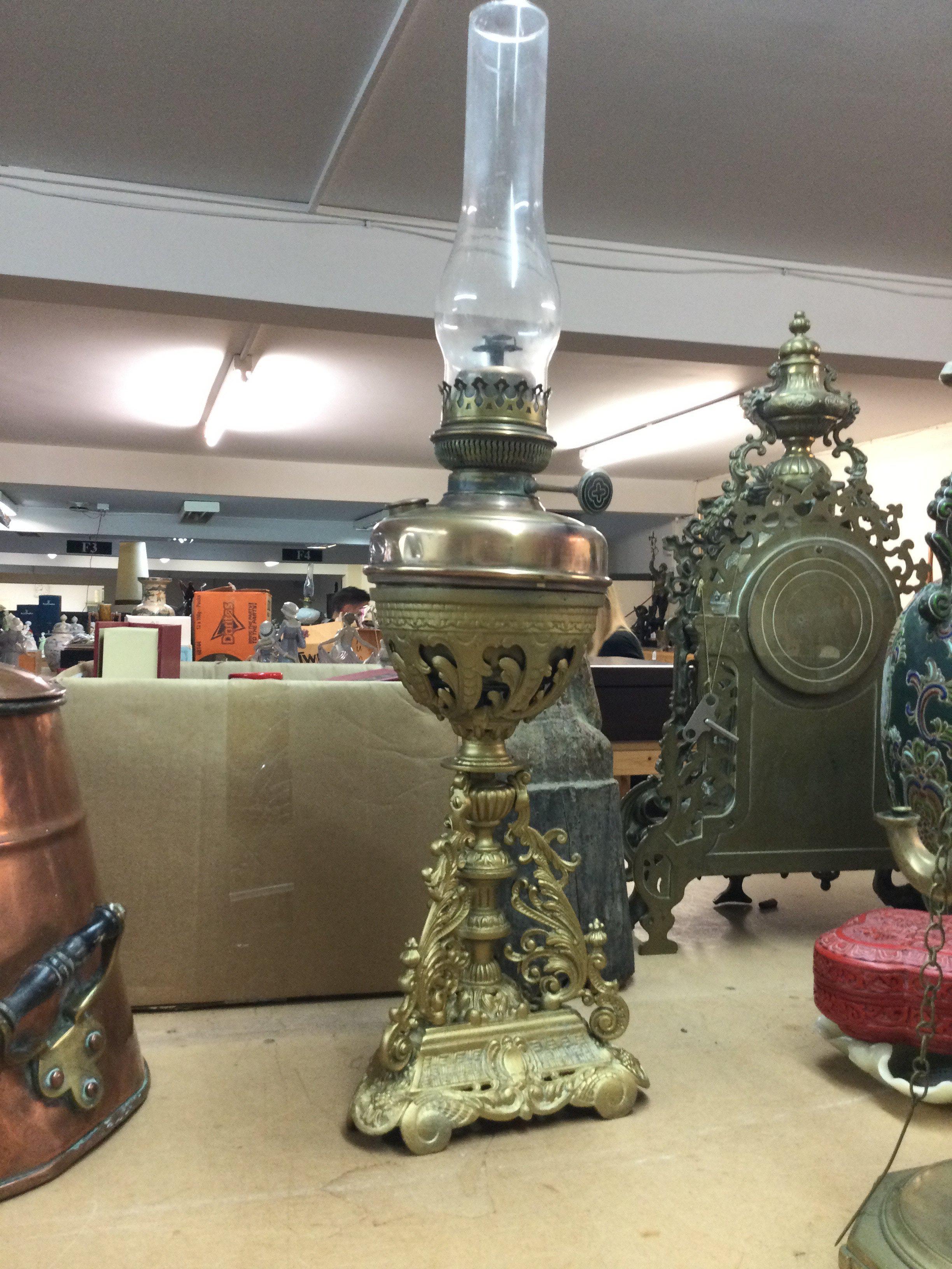 A Victorian oil lamp on gilt metal base with funnel . 68cm tall total height. This lot cannot be posted