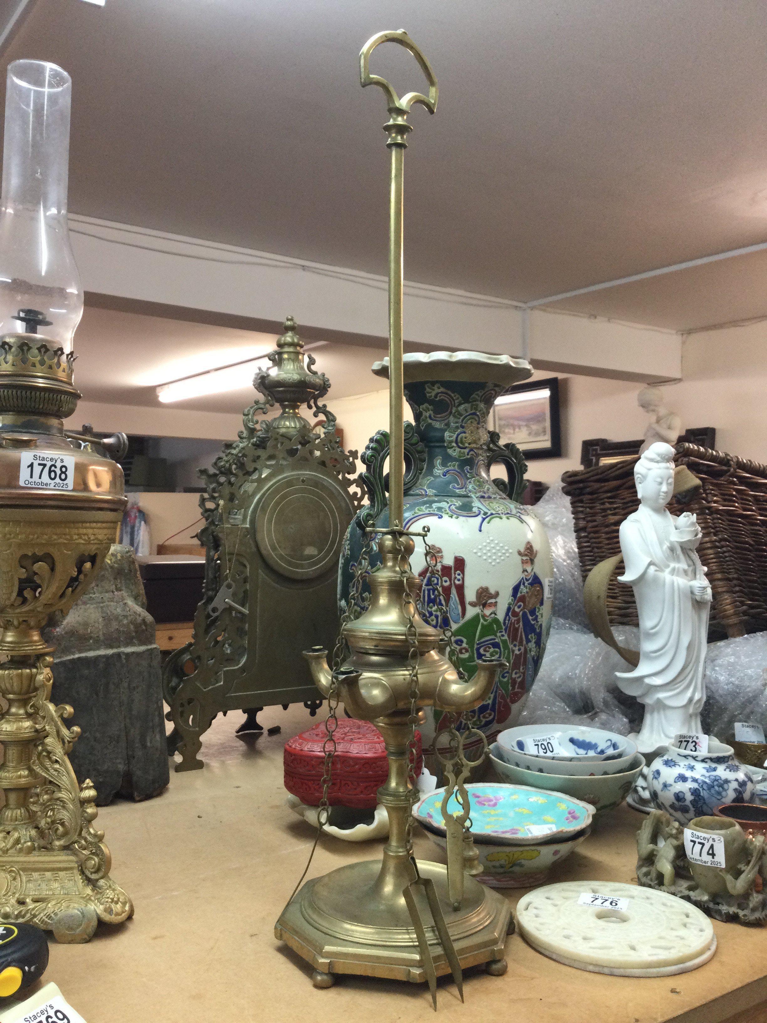 A brass standing oil lamp , 68cm tall