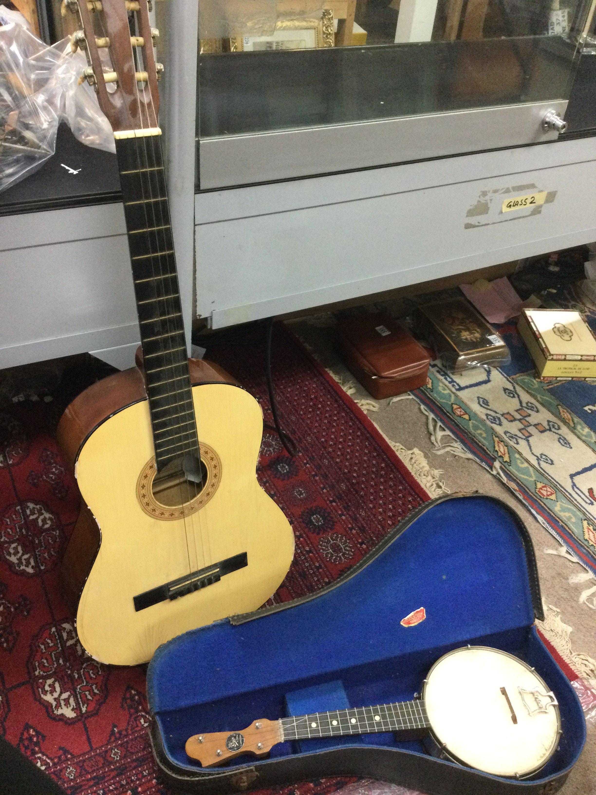 An acoustic Horner model MC 05 classical acoustic guitar and cased a John Grey & Sons Banjolele