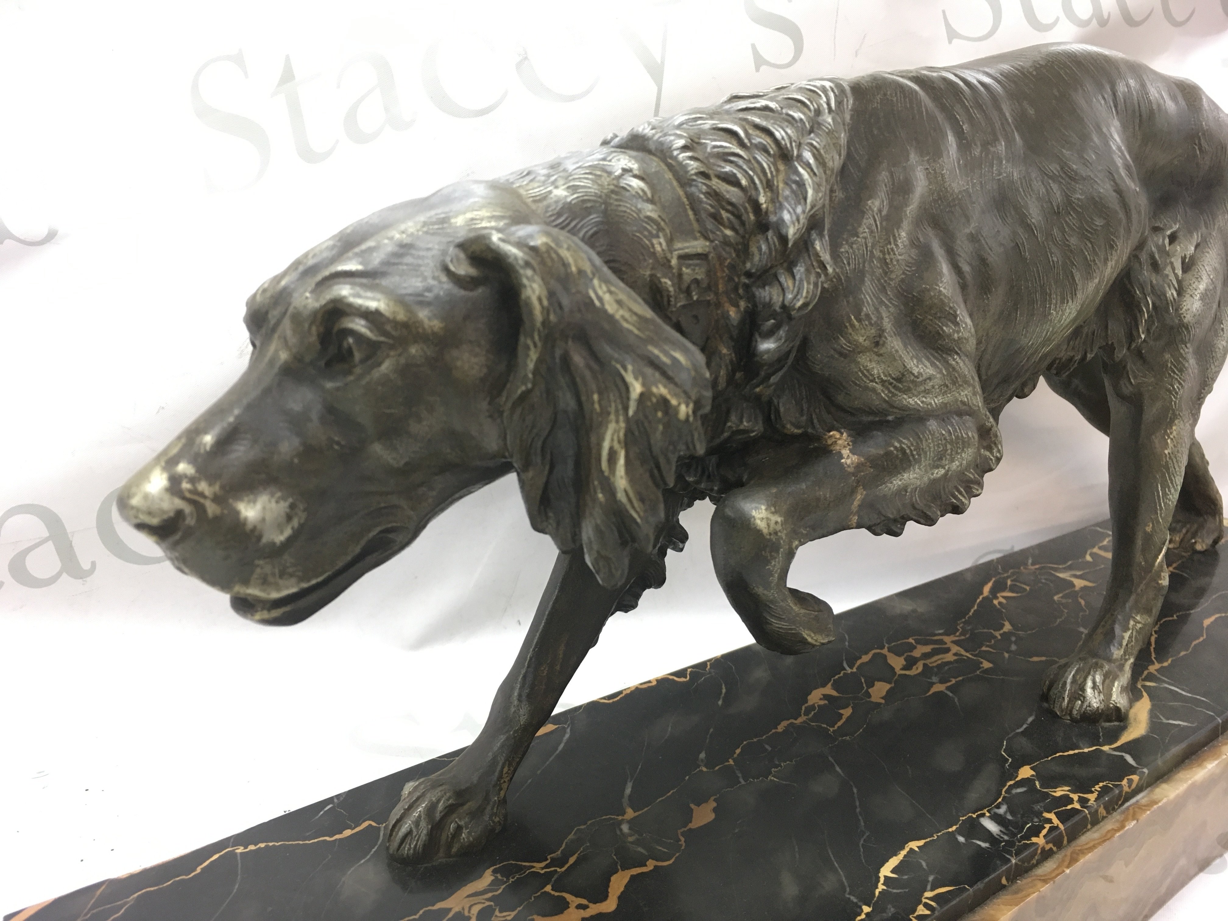 Art Deco spelter figure of a gun dog on a marble base 27.5cm tall 60cm wide.
