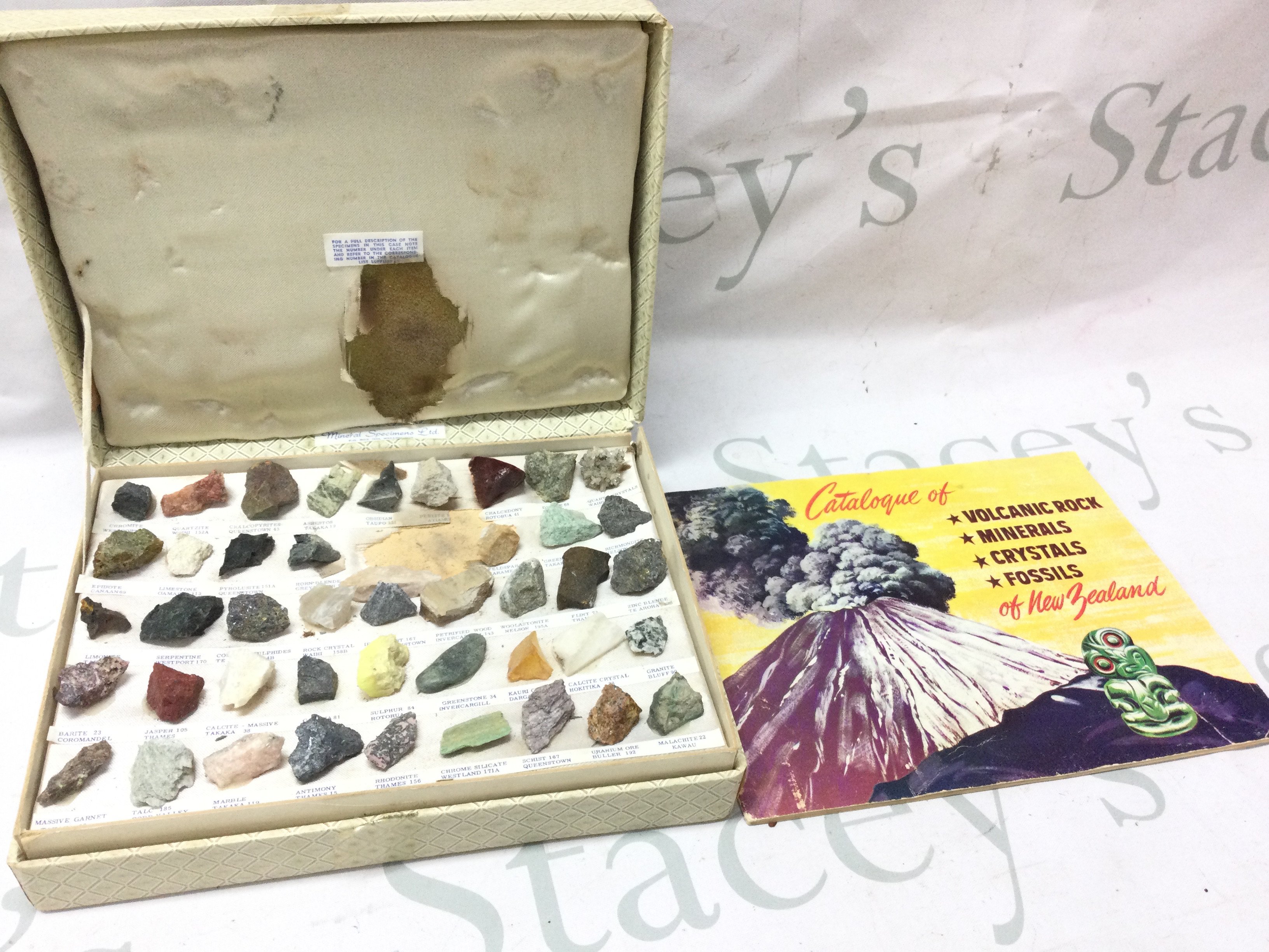 A box of New Zealand rocks and crystals with catalogue in original box . Postage category B