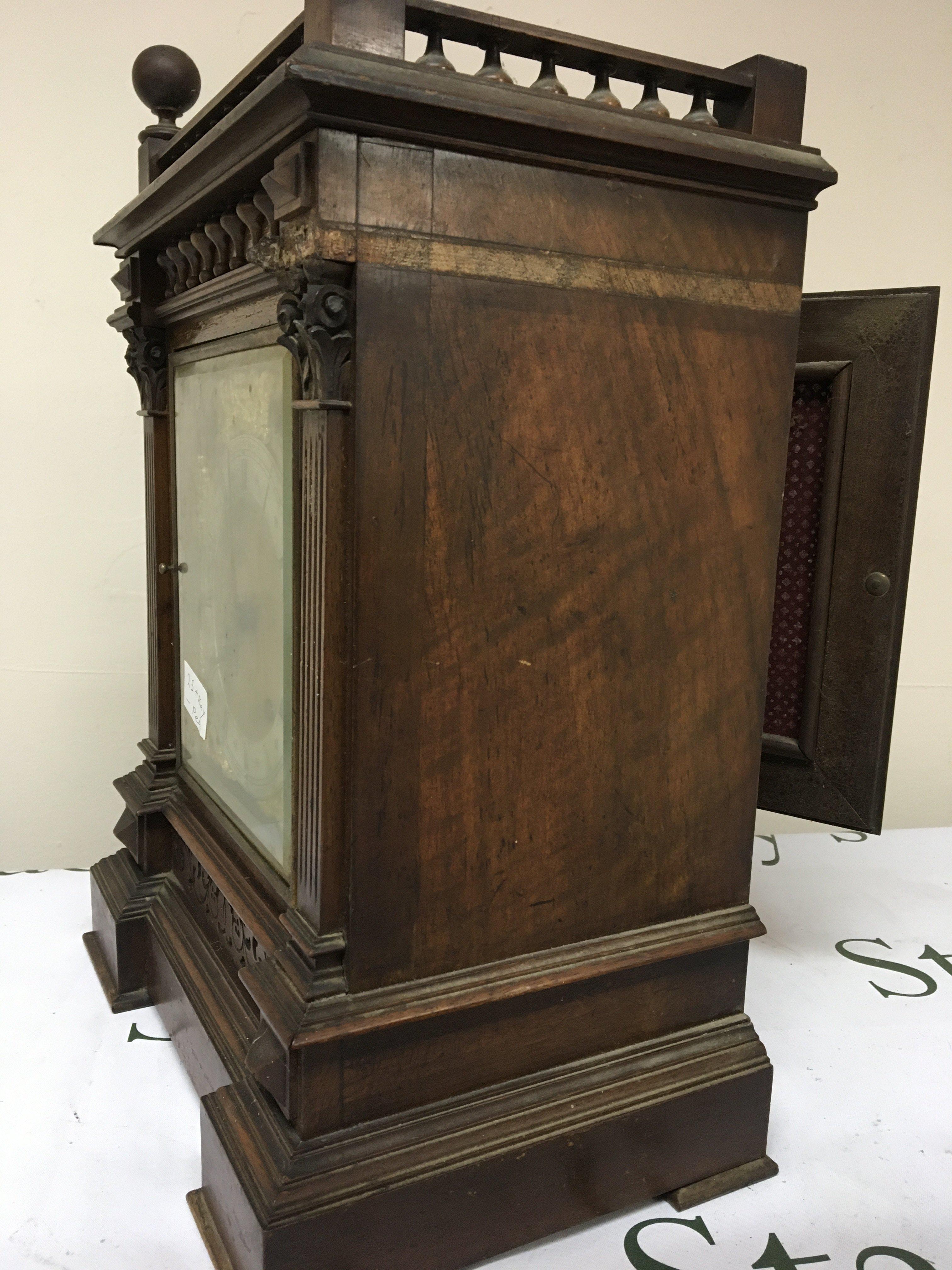An Edwardian walnut cased mantel clock the case with a gallery above half pilasters silvered chapter ring dial with S Smith & Son Ltd Strand London. With strike silent subsidiary dial key and pendulum 44cm heigh