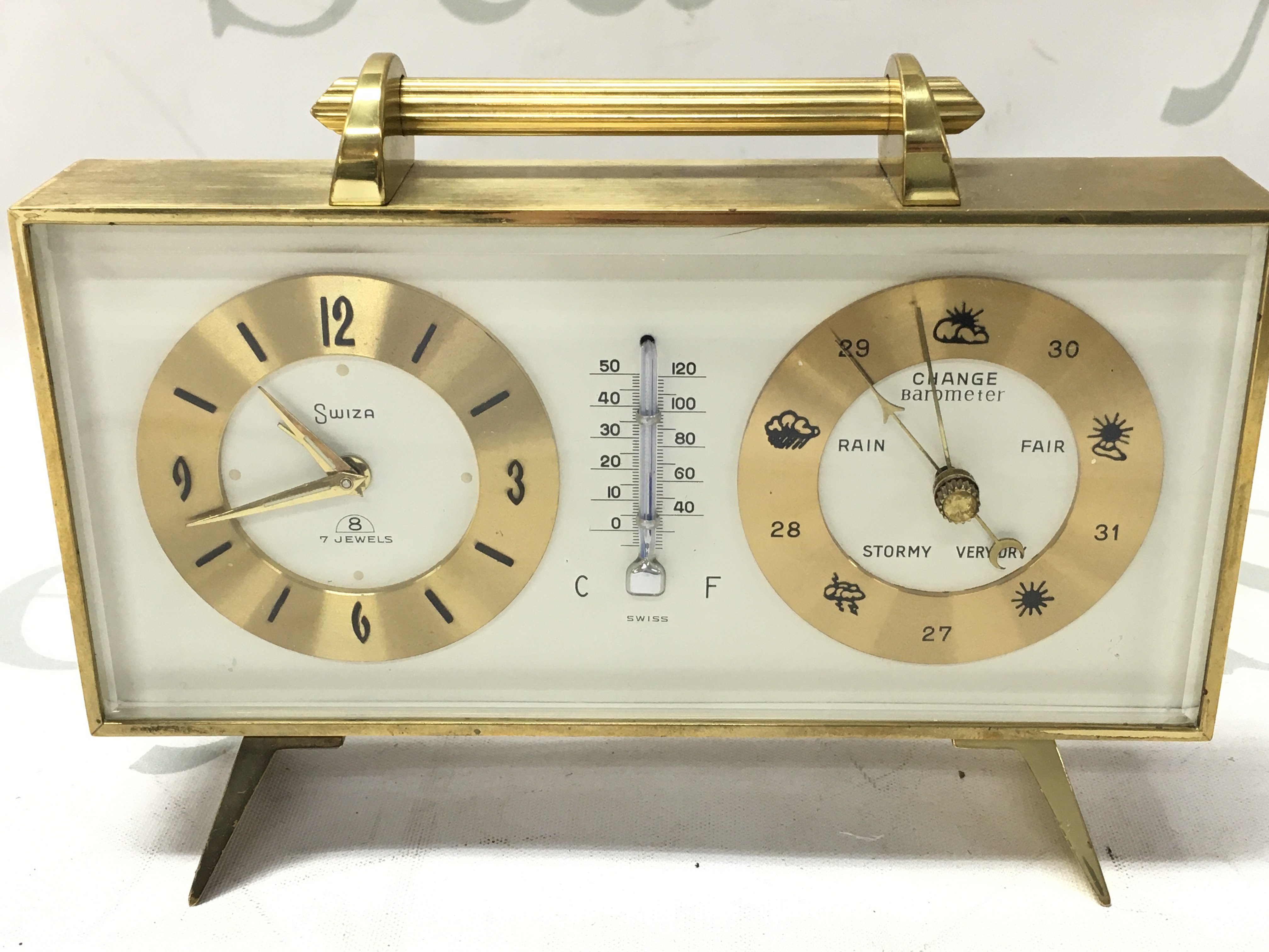 A vintage Swiza 8 day 7 jewels clock with mercury therometer barometer solid brass (working)