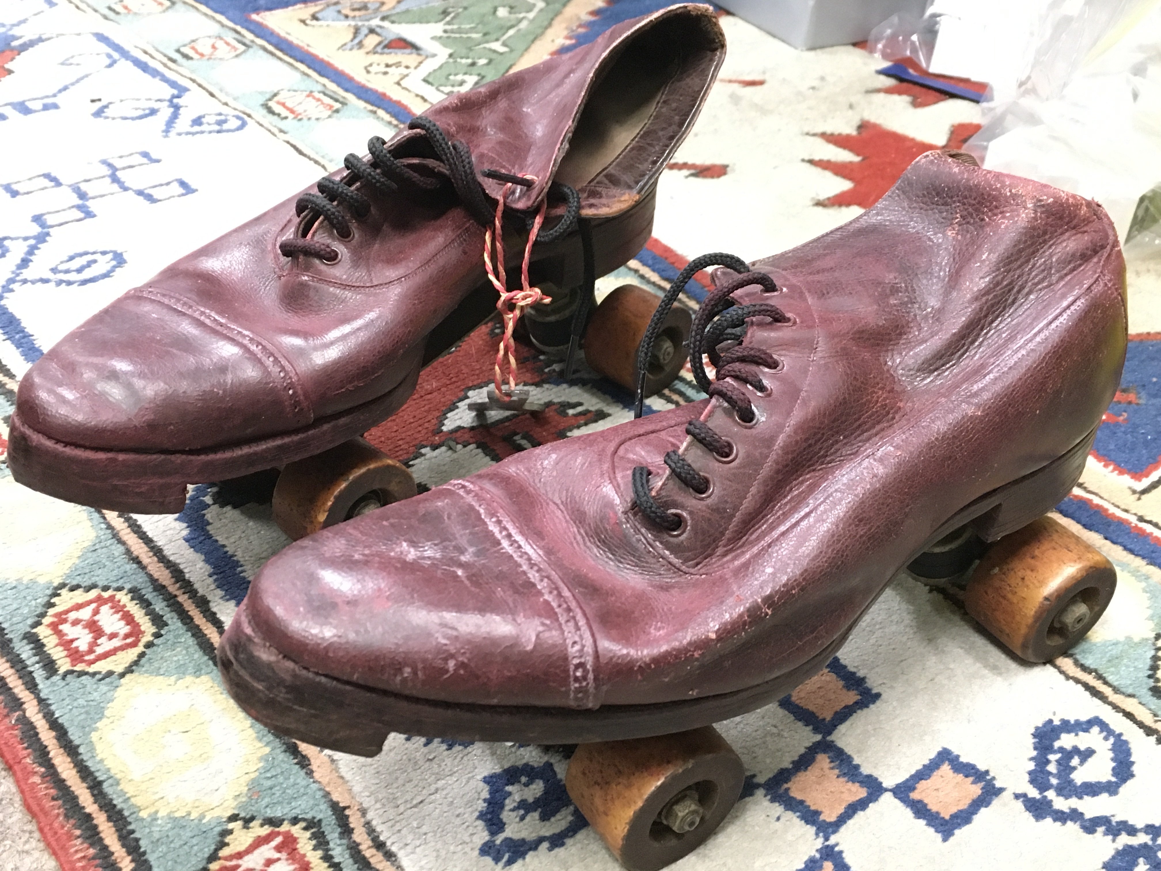 A pair of vintage leather roller skates . postage cat C- NO RESERVE
