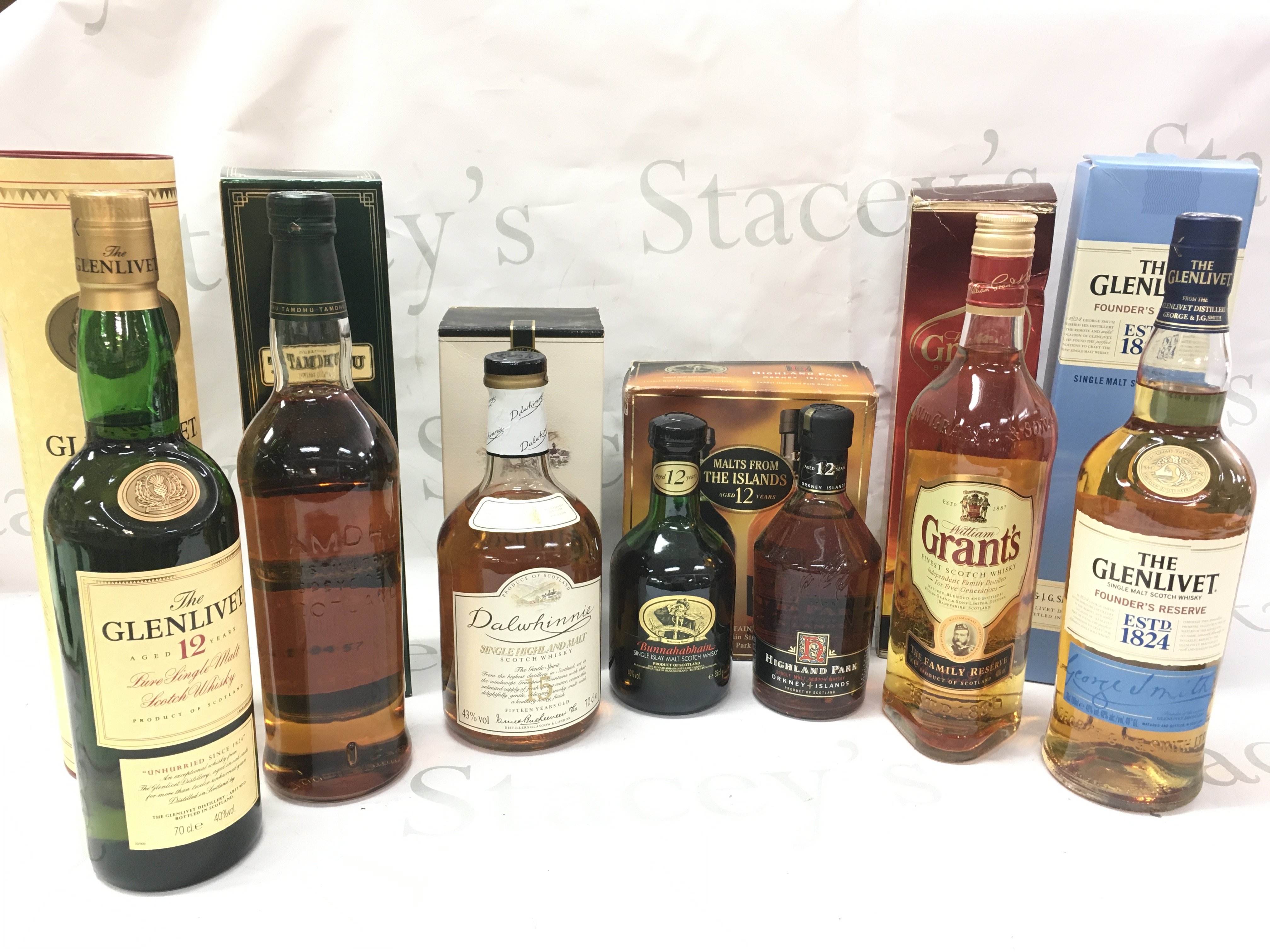 A collection of boxed whiskeys including Glenlivet single malt, Grants blended, Highland park single malt 12 year , Bunnahabhain single malt 12 year, Dalwhinnie 15 year, Tamdhu single malt, Glenlivet 12 year. This lot cannot be posted