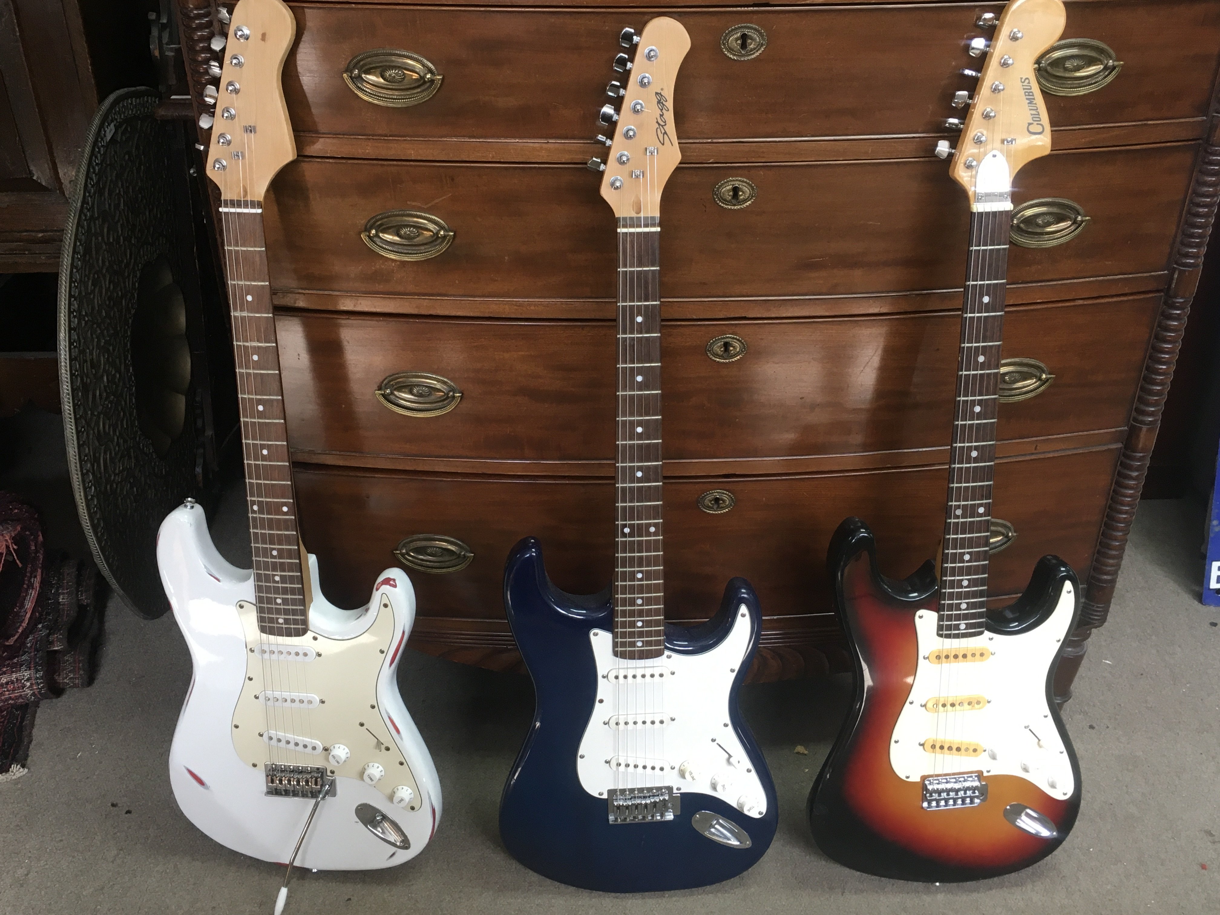 A collection of strat style electric guitars including a Stagg and a Columbus. Including one gig bag. This lot cannot be posted