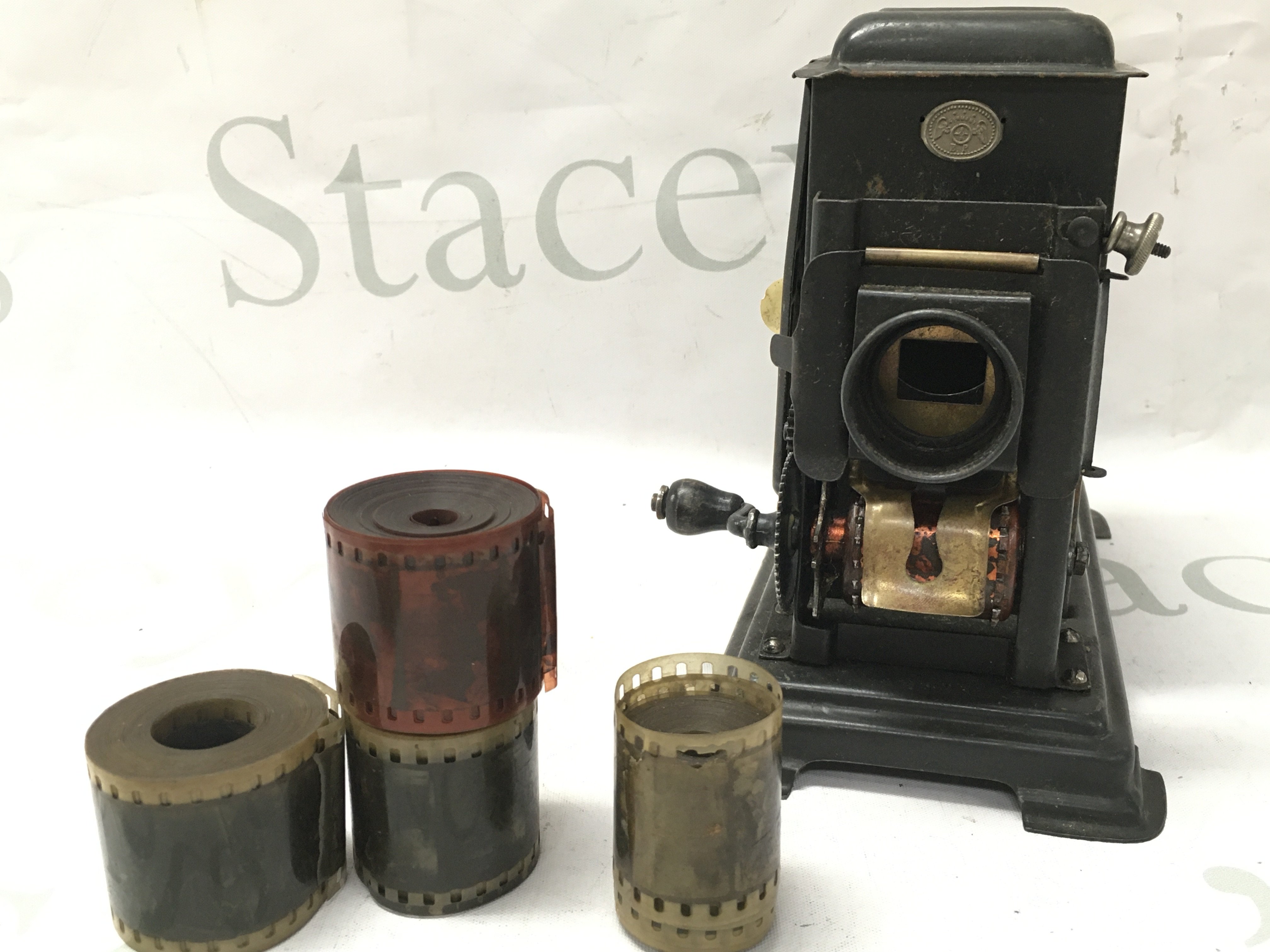 Vintage German lantern hand operated film projector with some reels . Most appear to be military marches. No reserve . Postage cat b