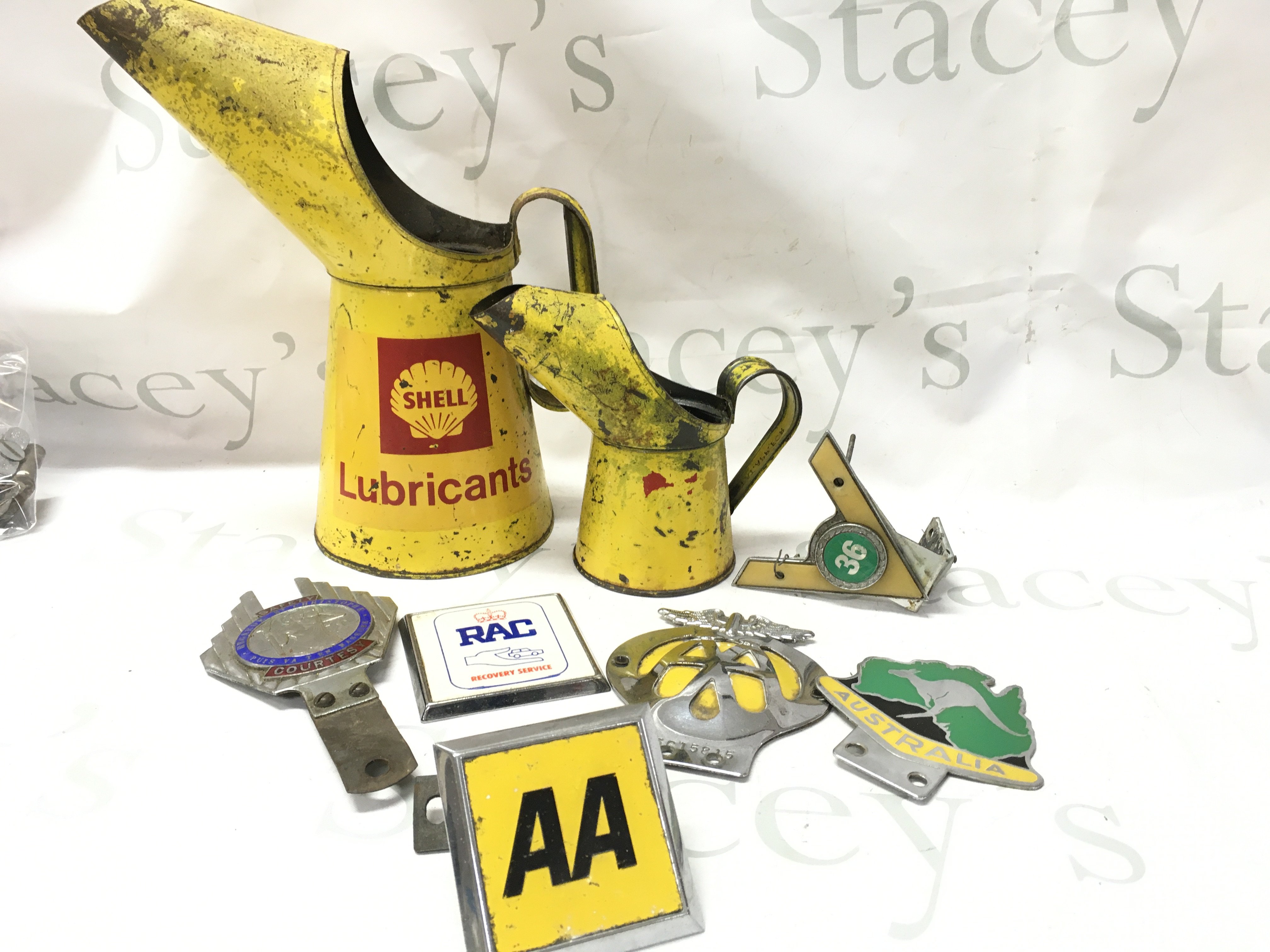 Vintage motoring items including two shell lubricant cans, AA badges, Australia car badge, St Christopher car badge etc . No reserve postage category C