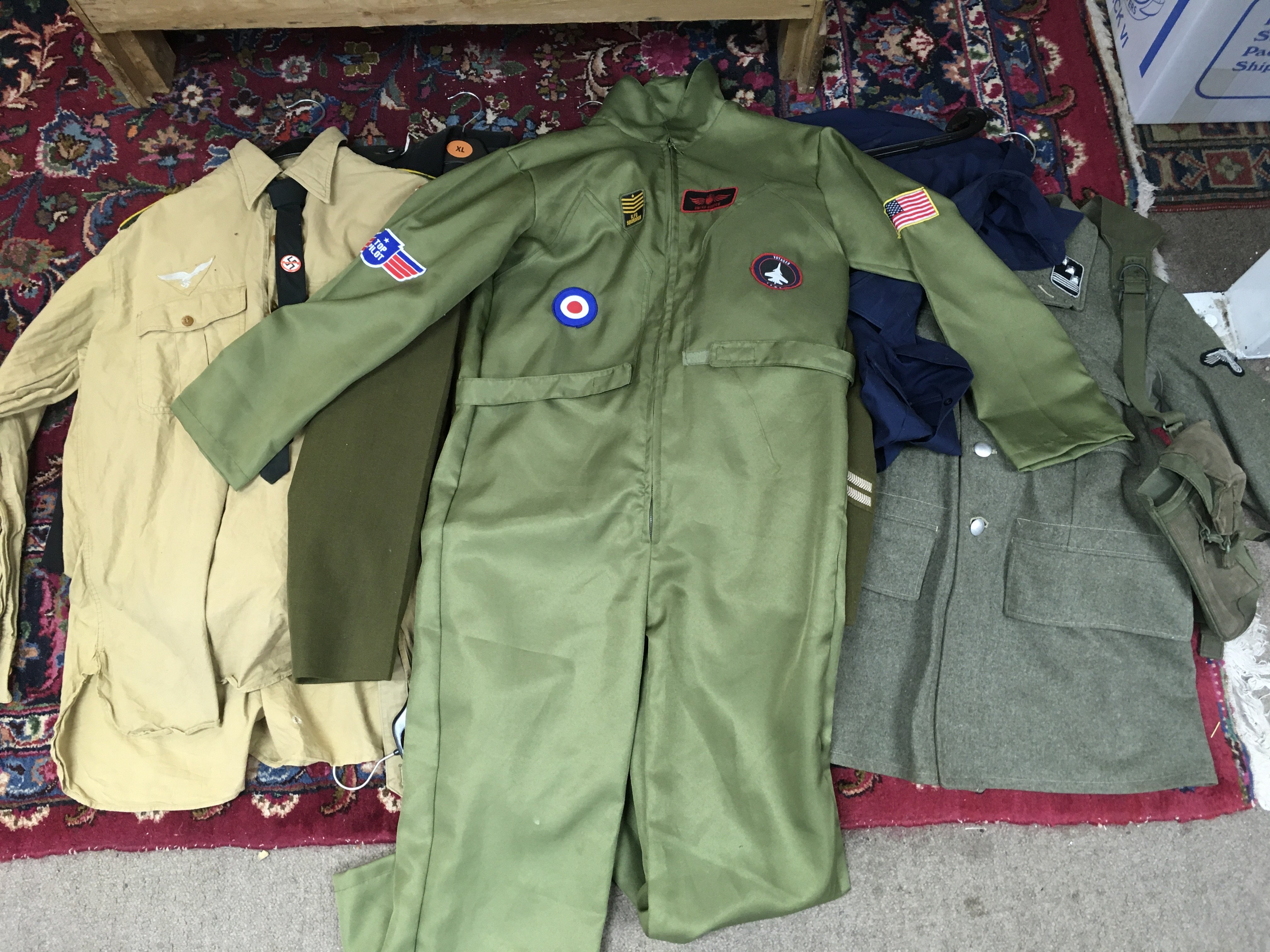 A collection of retrospective military uniforms including a Waffen SS field-grey wool jacket with Sicherheitspolizei (SD) badge, Grenadier Guarss jacket , Afrikakorps shirt, webbing etc