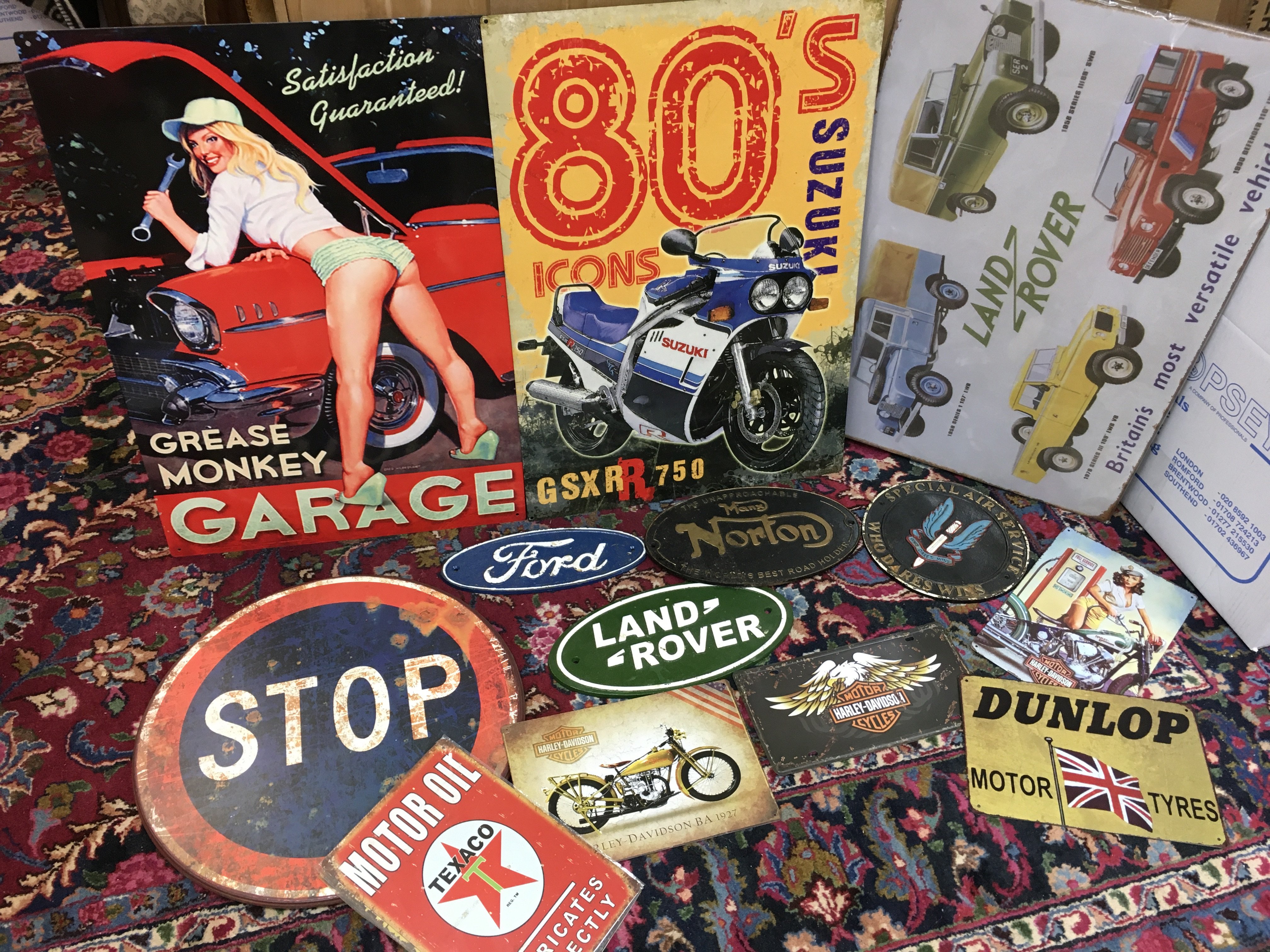 A collection of metal advertising signs , including cast iron special air service who dares wins sign, Norton, Ford, Land Rover . This lot cannot be posted