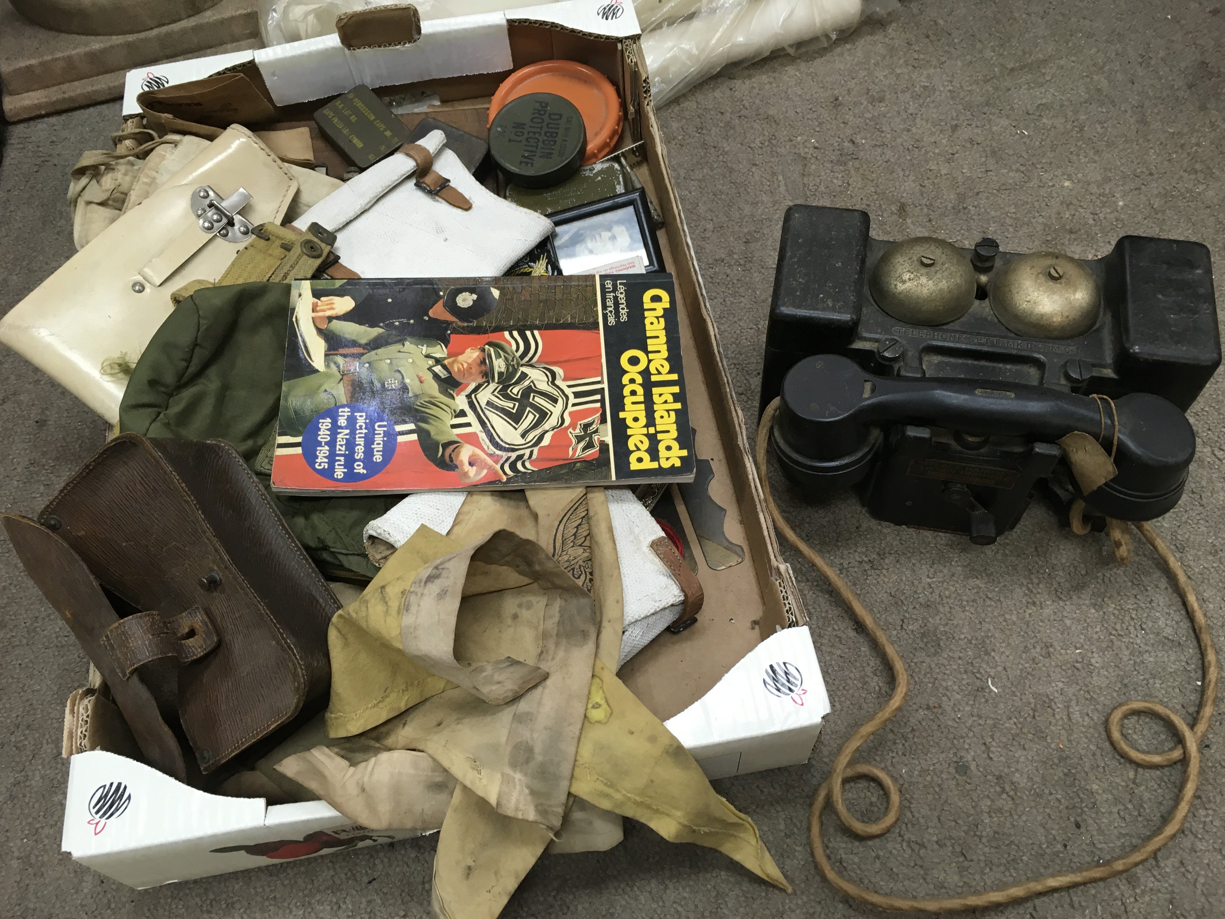 A collection of military items including a telephone set f mk 2 tmc, Luftwaffe flags, US Khaki army hat, Nazi medic arm band, Nazi small sacks,