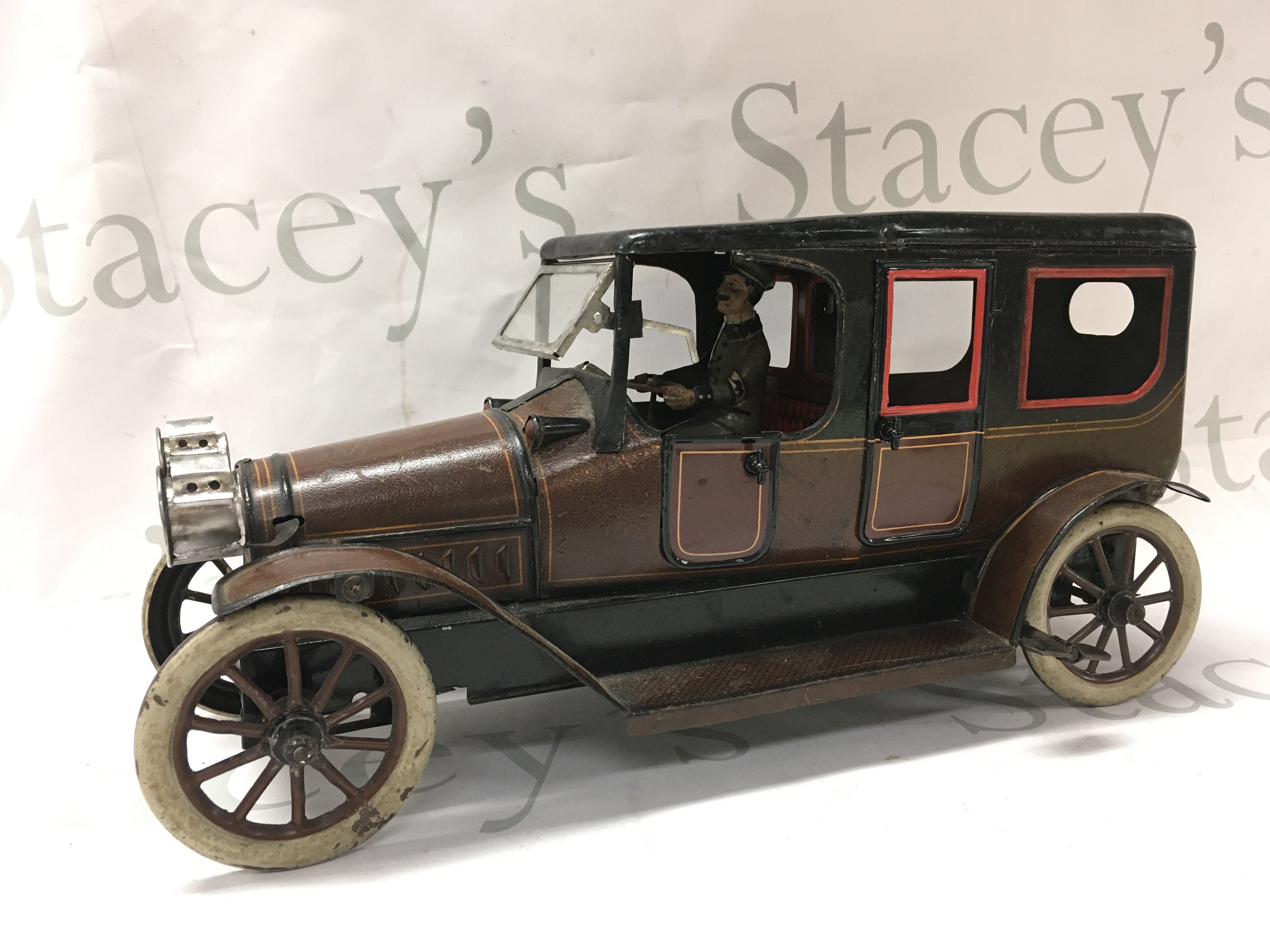 A Vintage clockwork tin model of a 6-light limousine. 35cm long 17.5cm tall Postage cat B