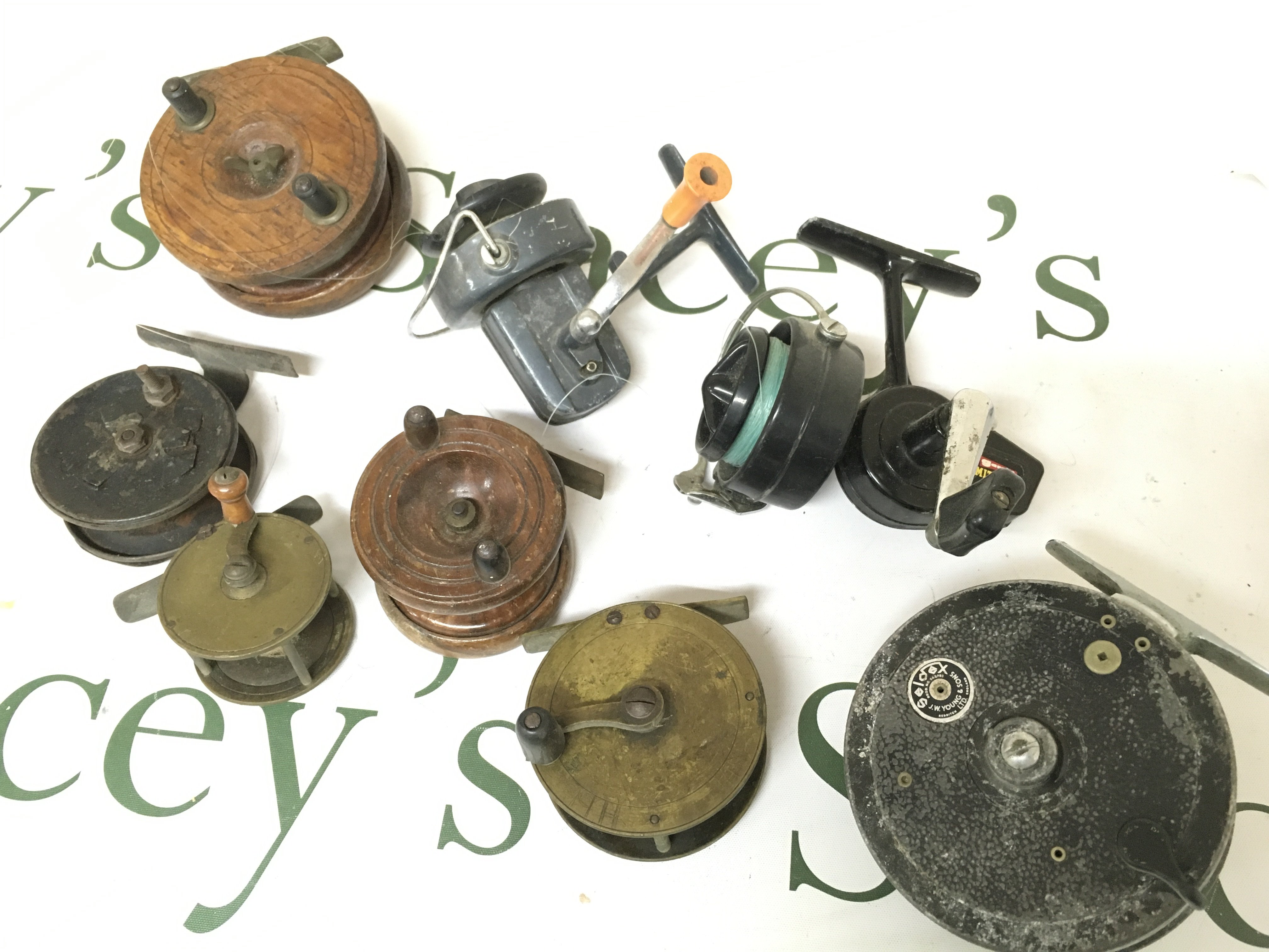 A collection of antique and vintage fly fishing reels including Seldex J.W YOUNG, brass and wooden reels , spinning reels including Garcia Mitchell 320 etc. postage cat B