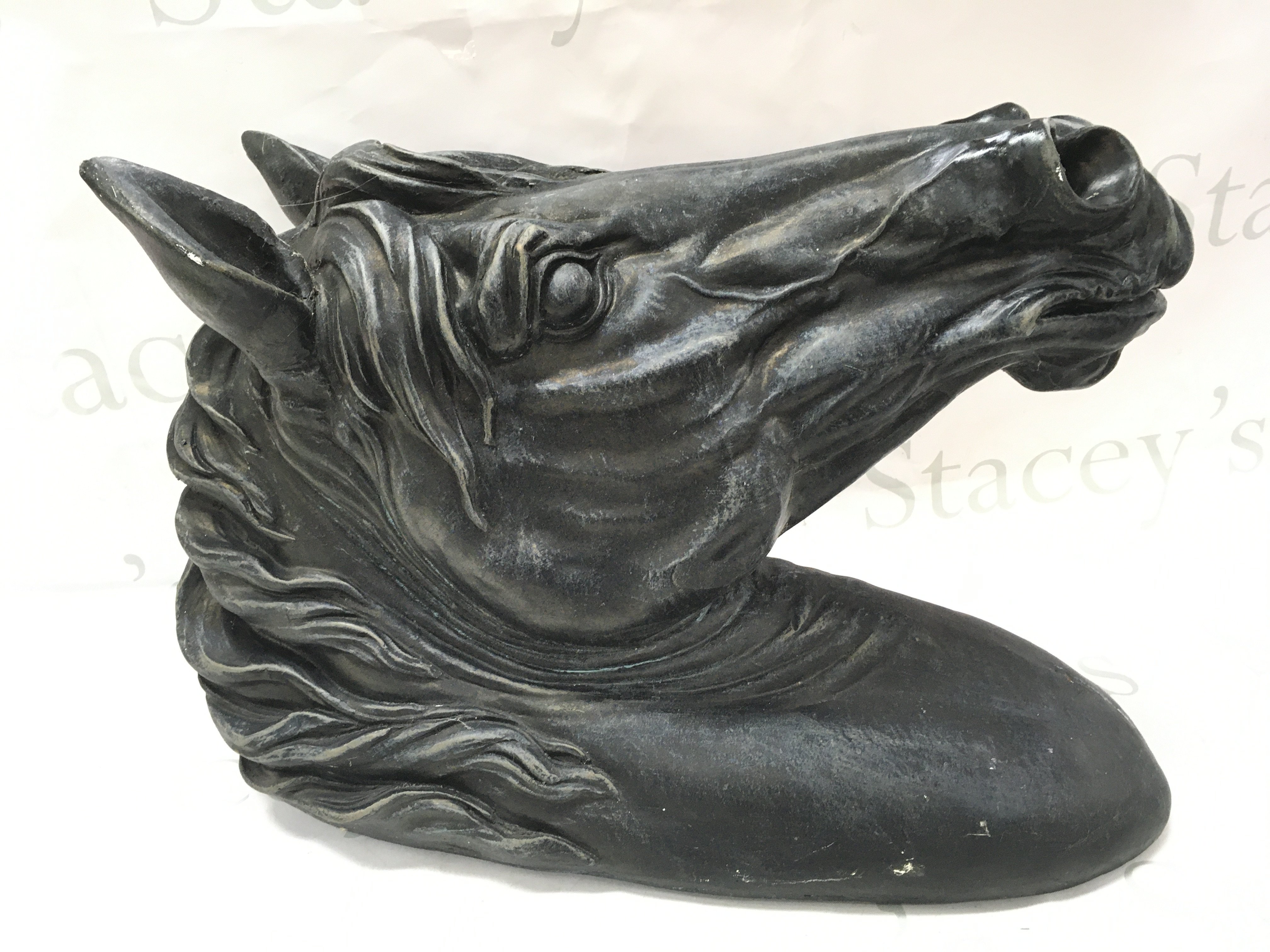 A vintage metal wall hanging horses head . 52cm tall 18cm wide approximately.This lot cannot be posted