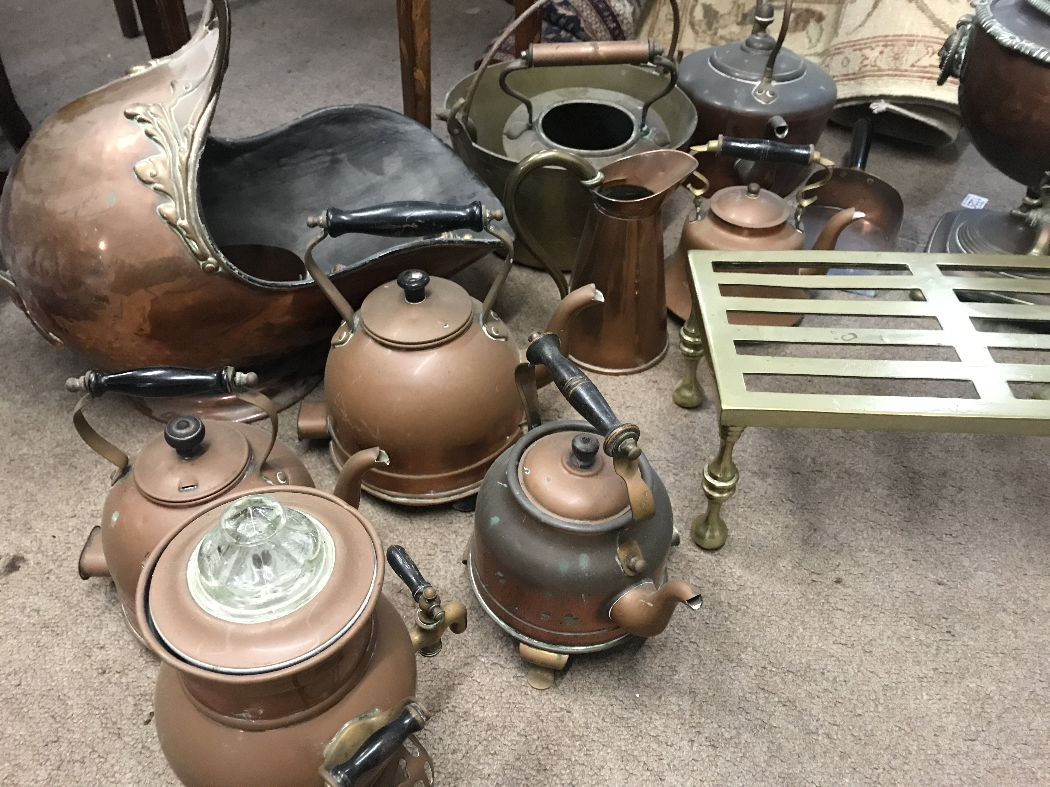 A collection of Copper jugs and kettles, Samovar , brass footman for fireplace, copper coal scuttle. This lot cannot be posted