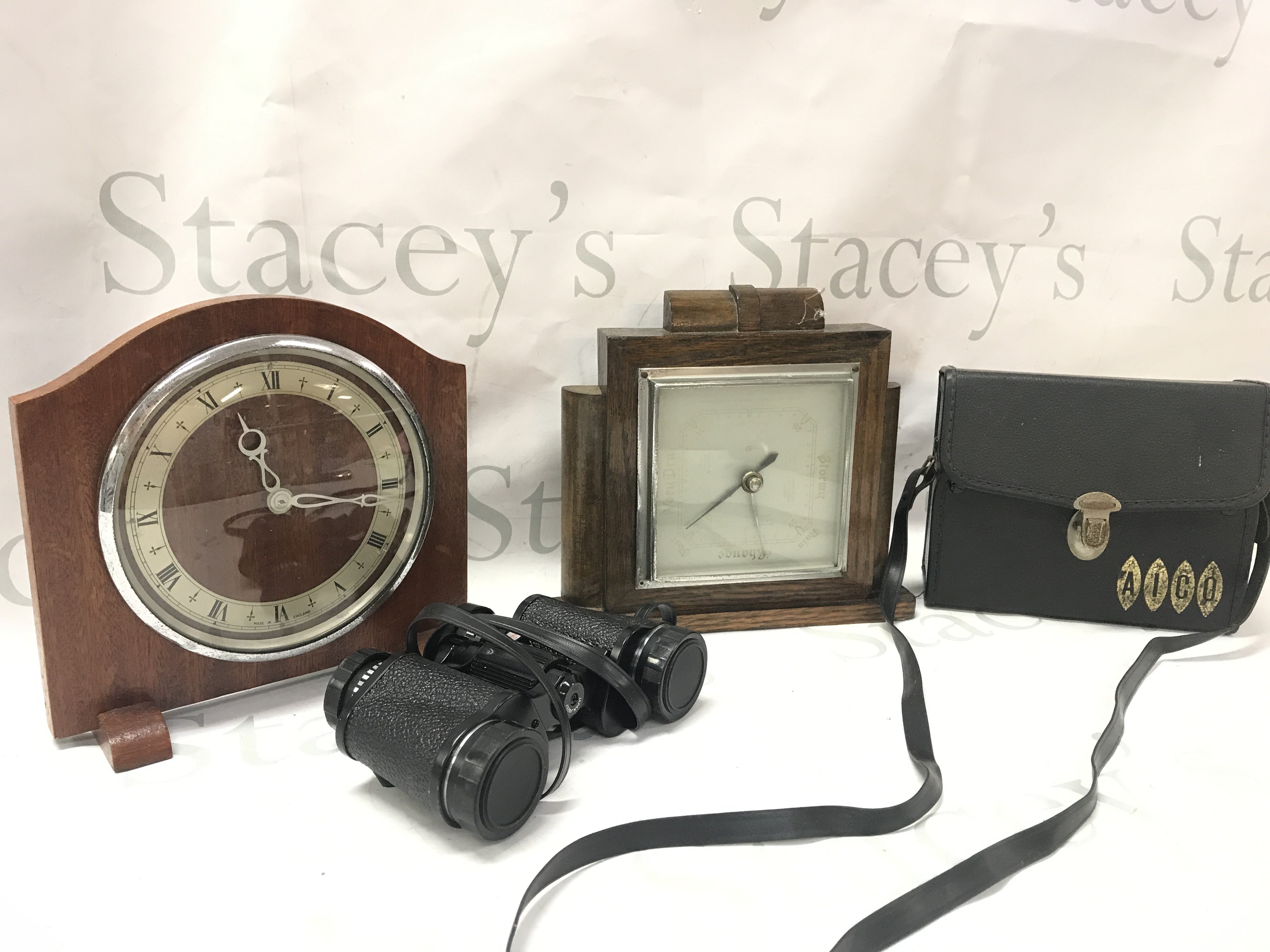 Two vintage clocks and a cased pair of Aicio 8x30 rapide binoculars. This lot cannot be posted